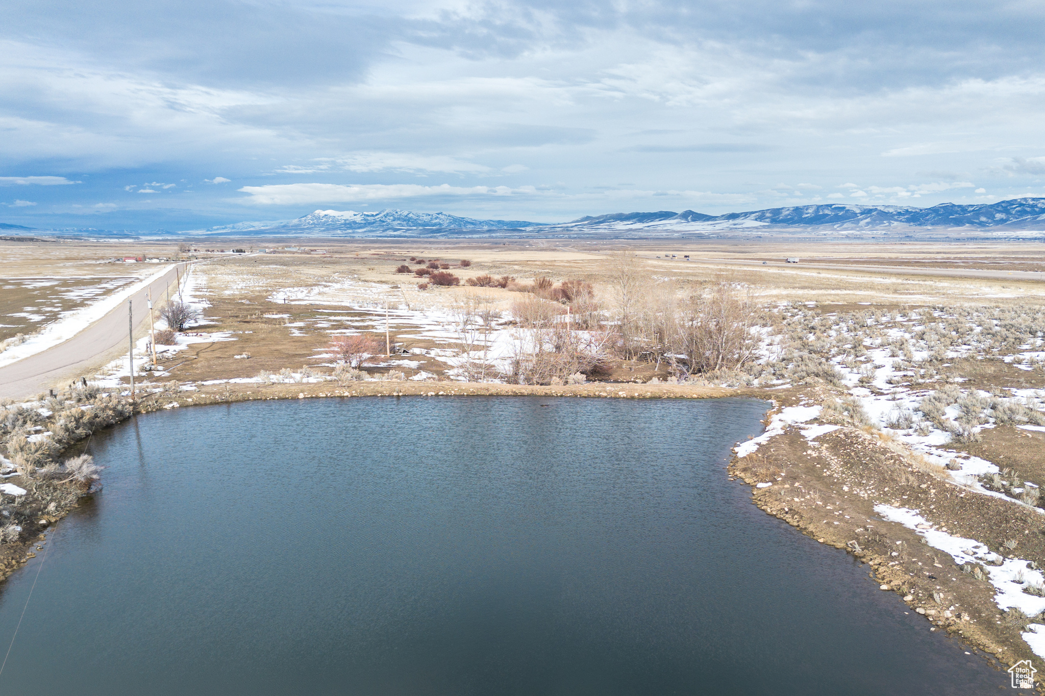 Aerial view featuring a water and mountain view