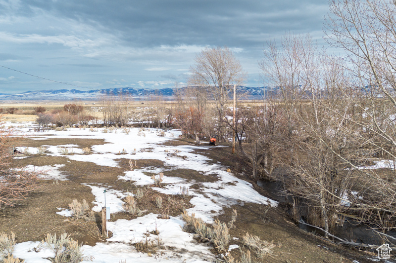 View of snow covered land featuring a mountain view