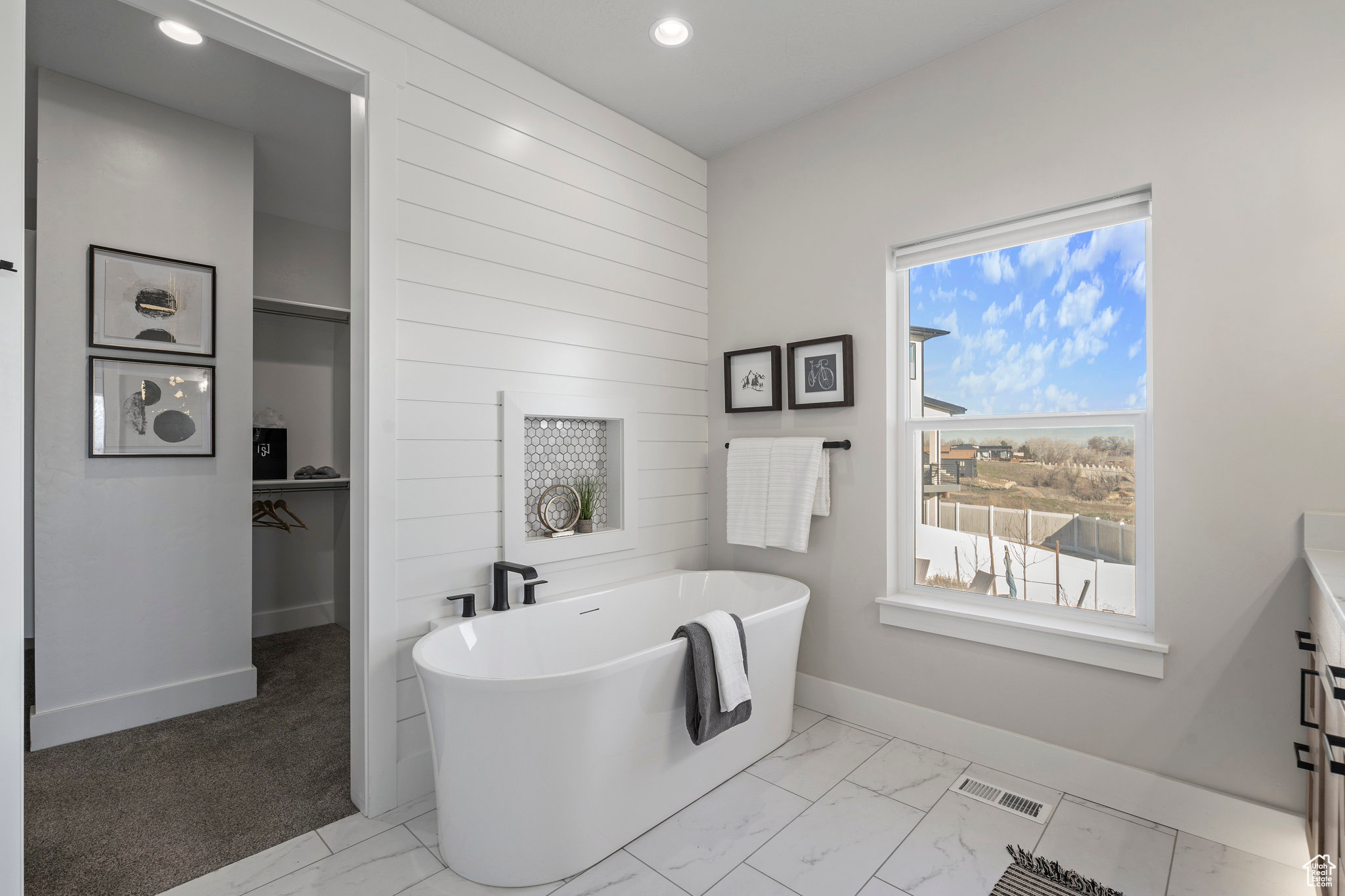 Bathroom featuring tile flooring and a washtub