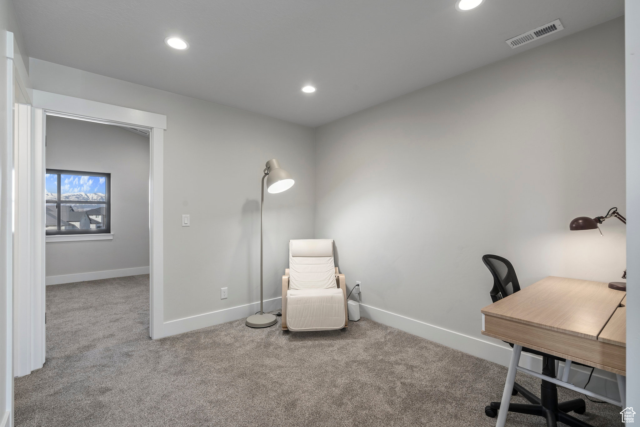 Home office featuring light colored carpet