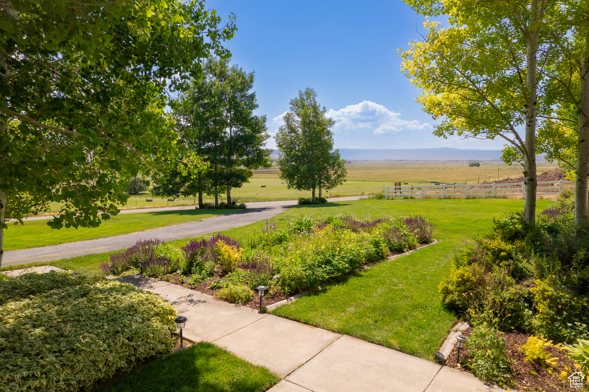 Surrounding community with a lawn and a rural view