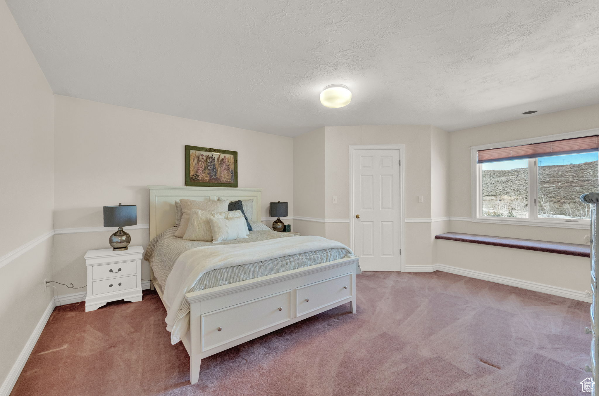 Bedroom featuring carpet flooring and a textured ceiling