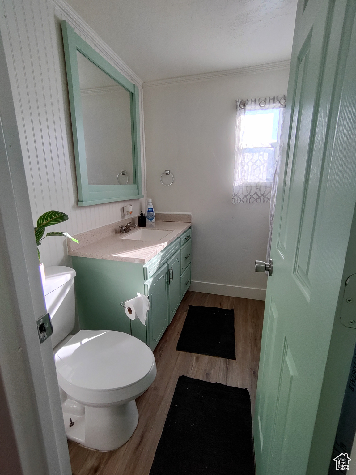 Bathroom with wood-type flooring, toilet, and vanity