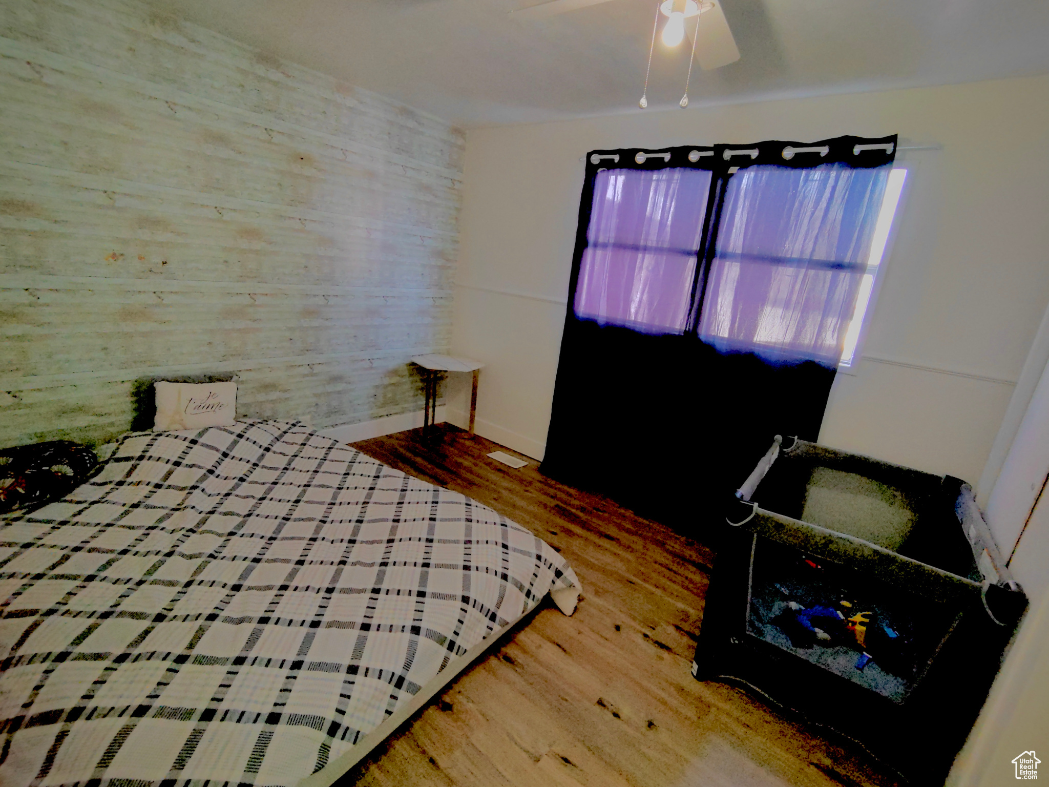 Bedroom with hardwood / wood-style flooring and ceiling fan