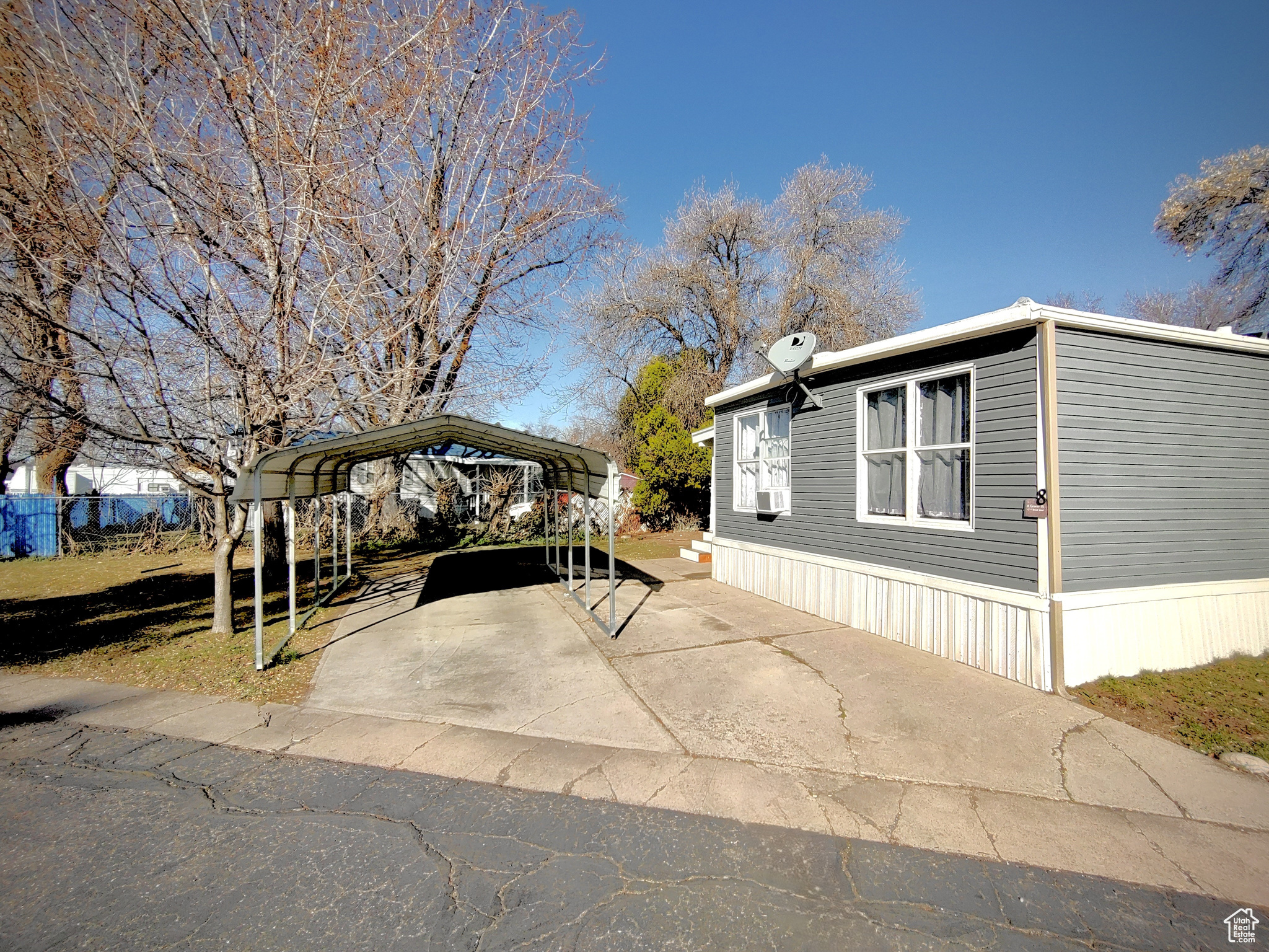 View of property exterior with a carport