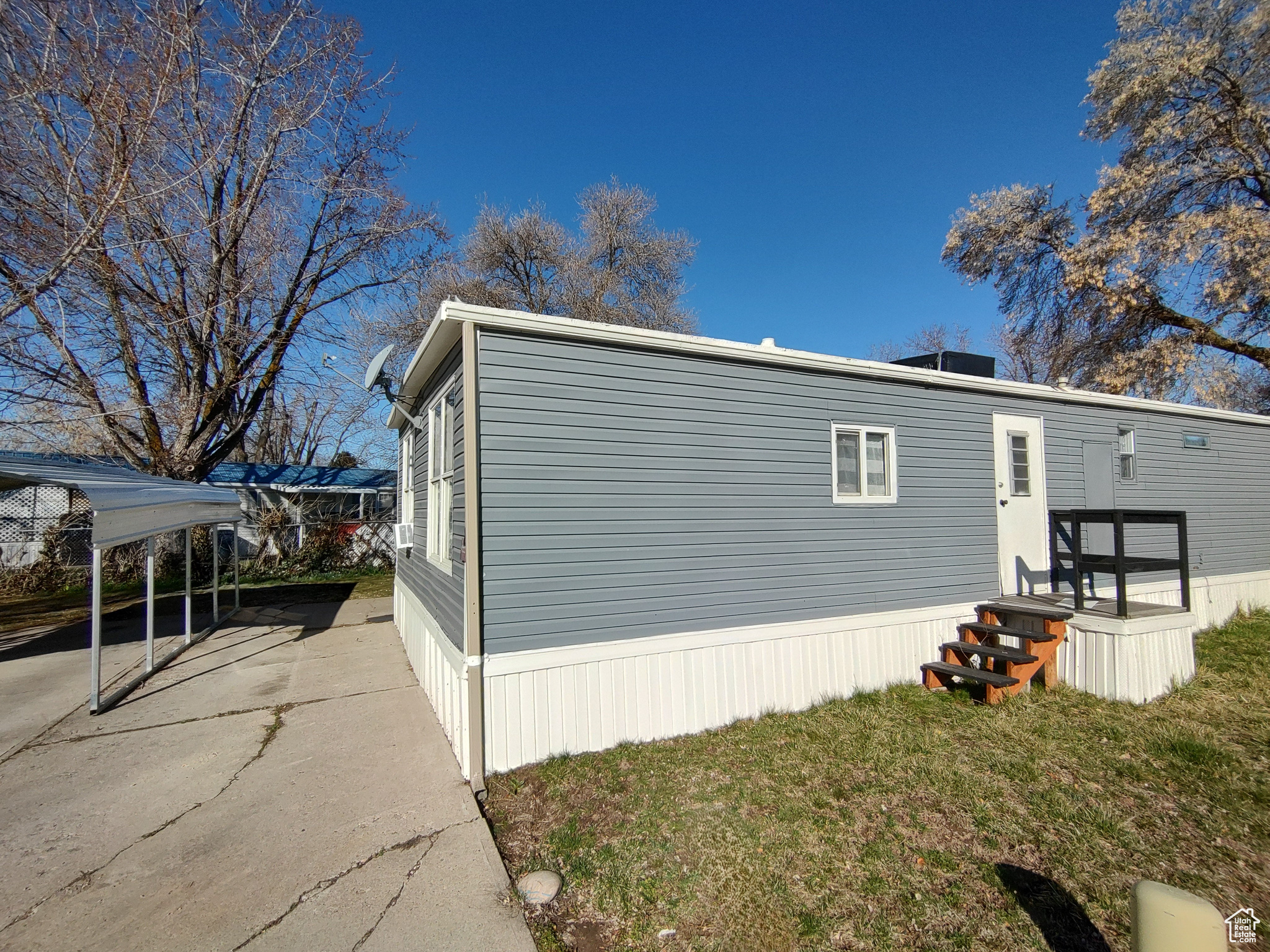 View of side of home featuring a lawn