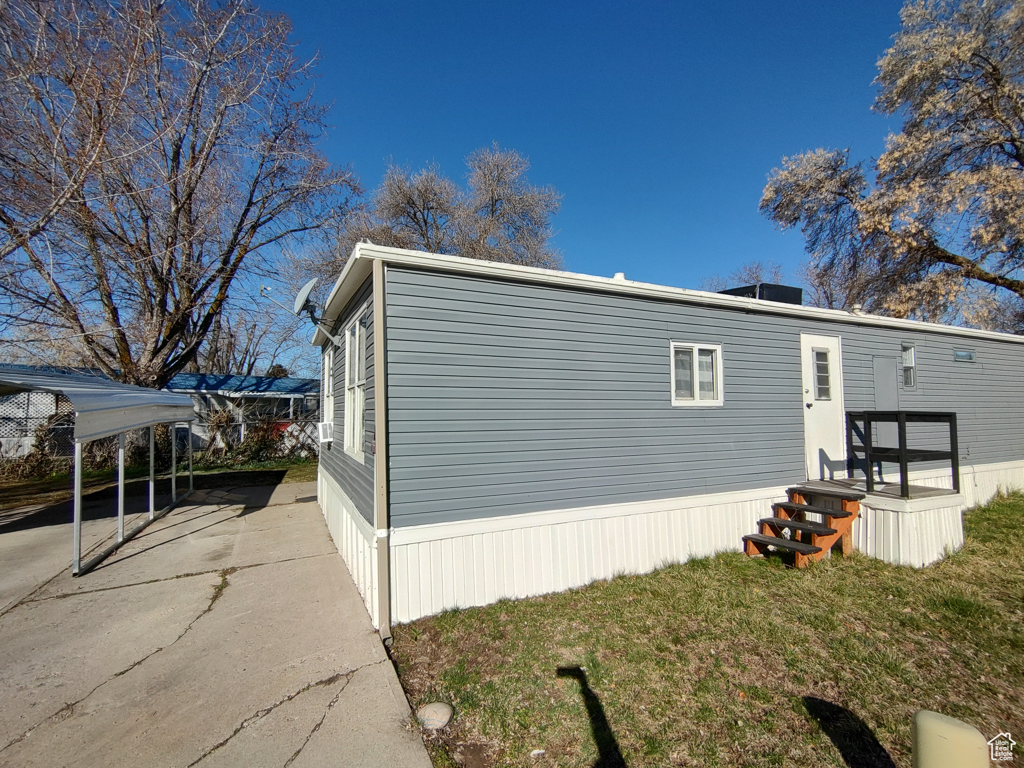 View of side of home featuring a lawn