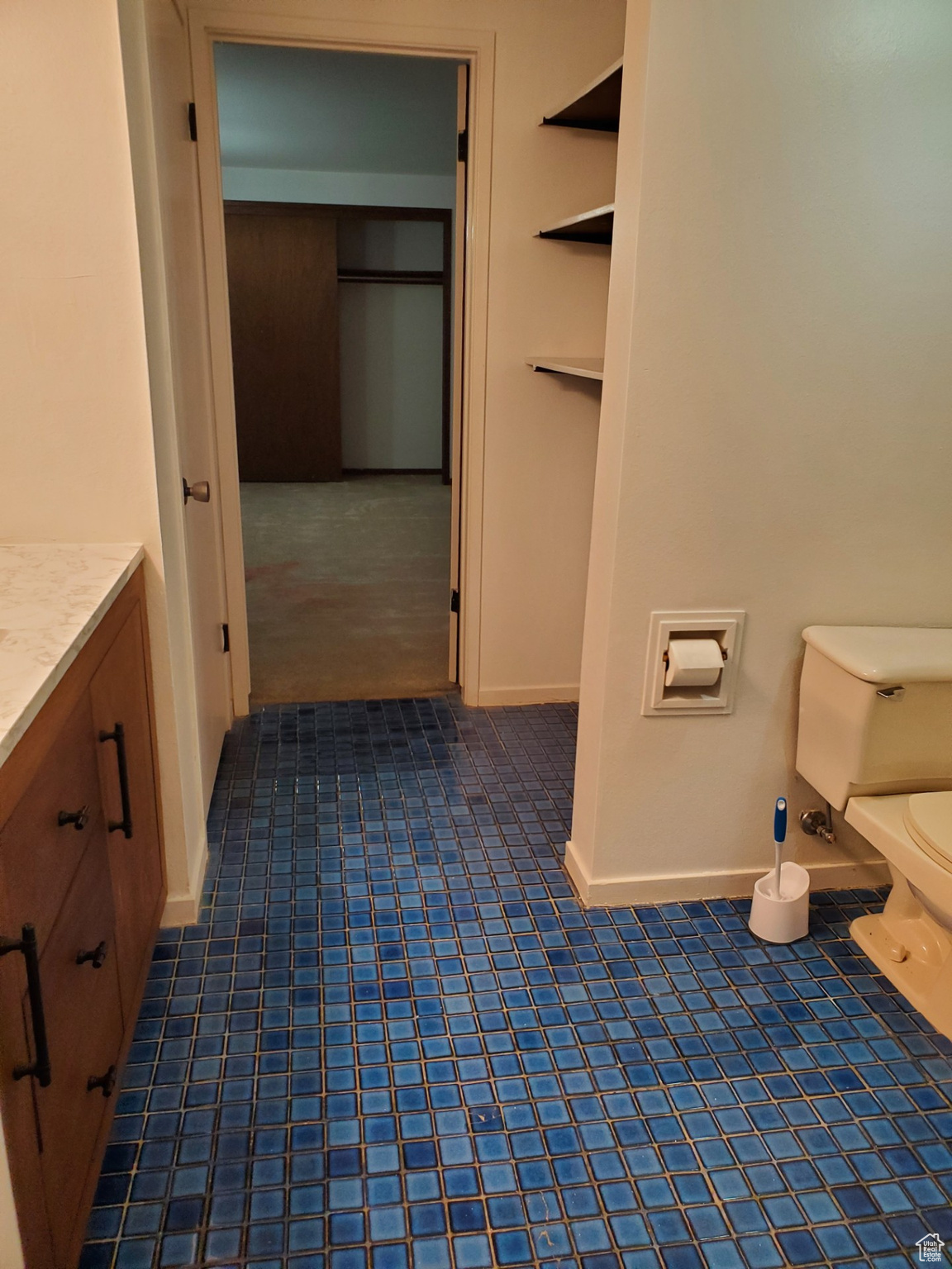 Corridor featuring dark tile flooring