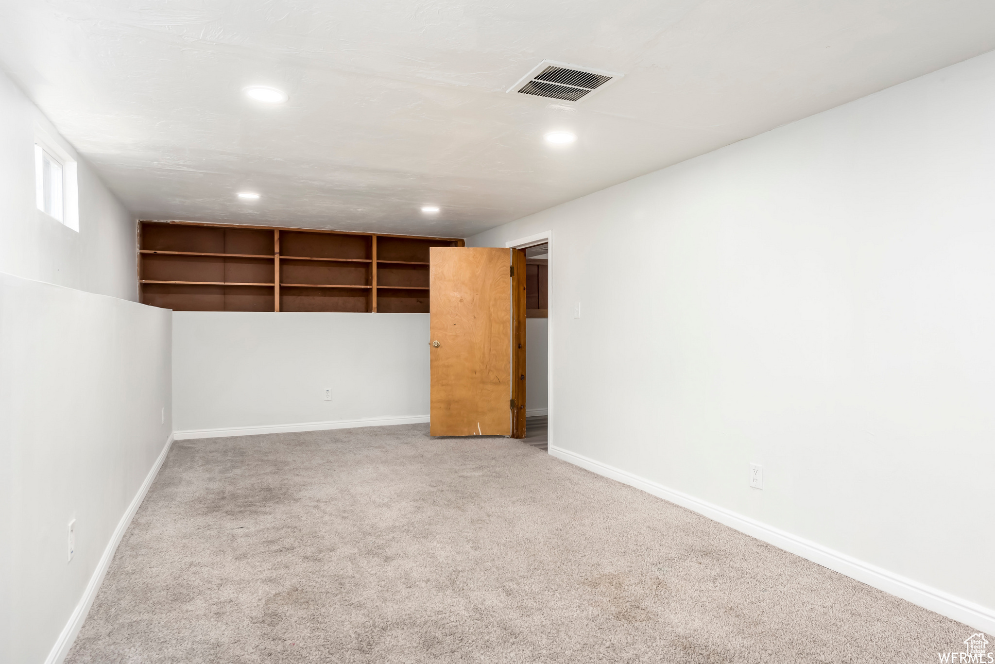 Interior space featuring light colored carpet