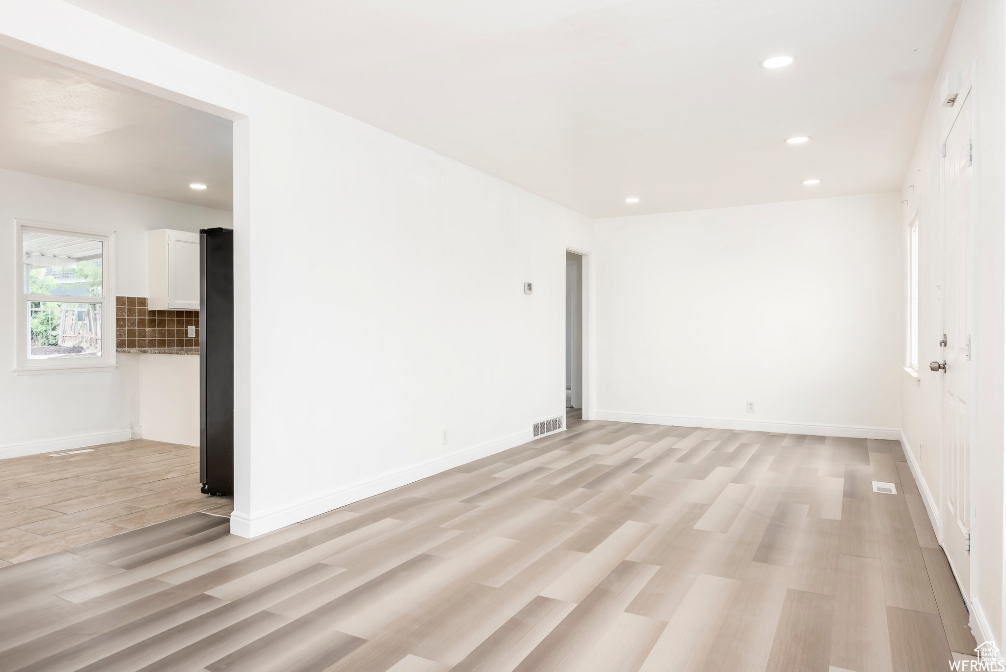 Spare room featuring light wood-type flooring