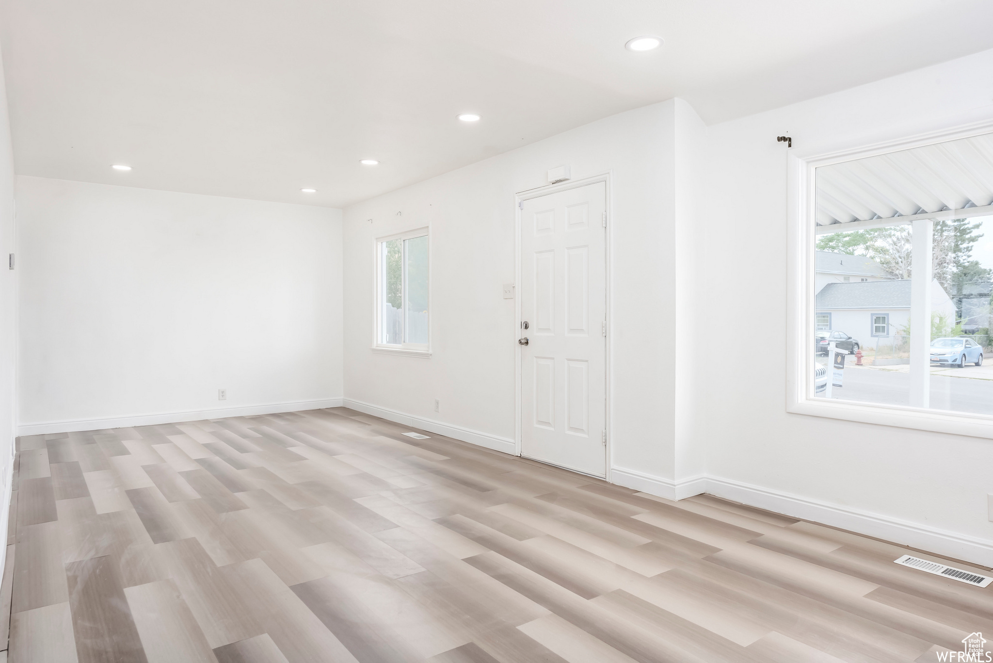 Spare room featuring light wood-type flooring