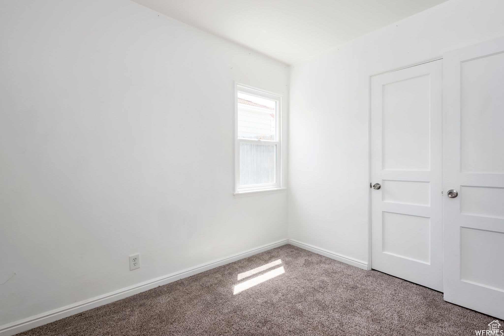 Unfurnished room with light carpet