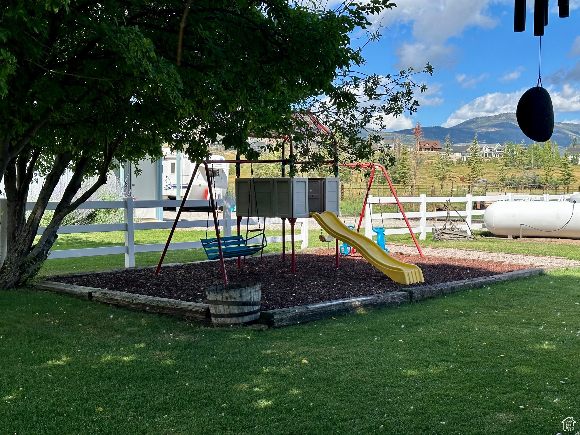 View of play area with a lawn and a mountain view