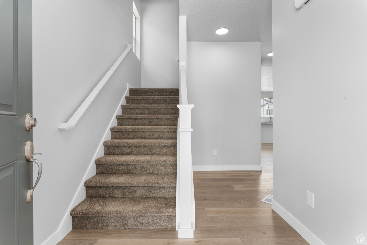 Stairs featuring hardwood / wood-style floors