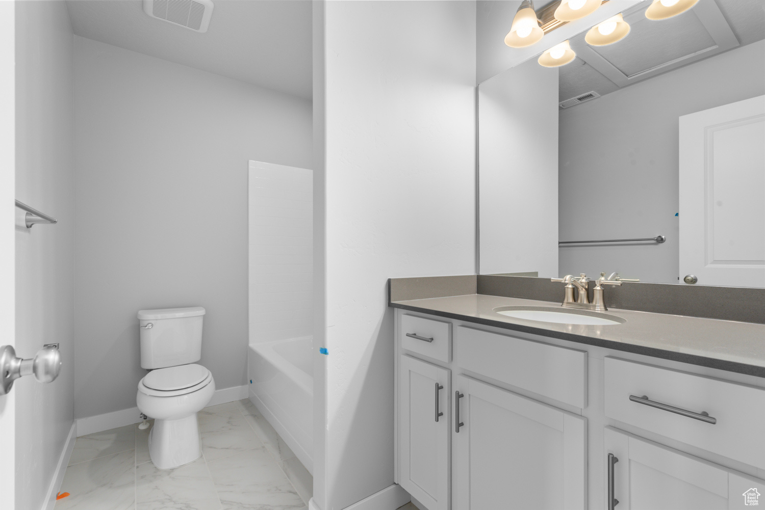 Full bathroom featuring tile flooring, oversized vanity, toilet, and bathing tub / shower combination