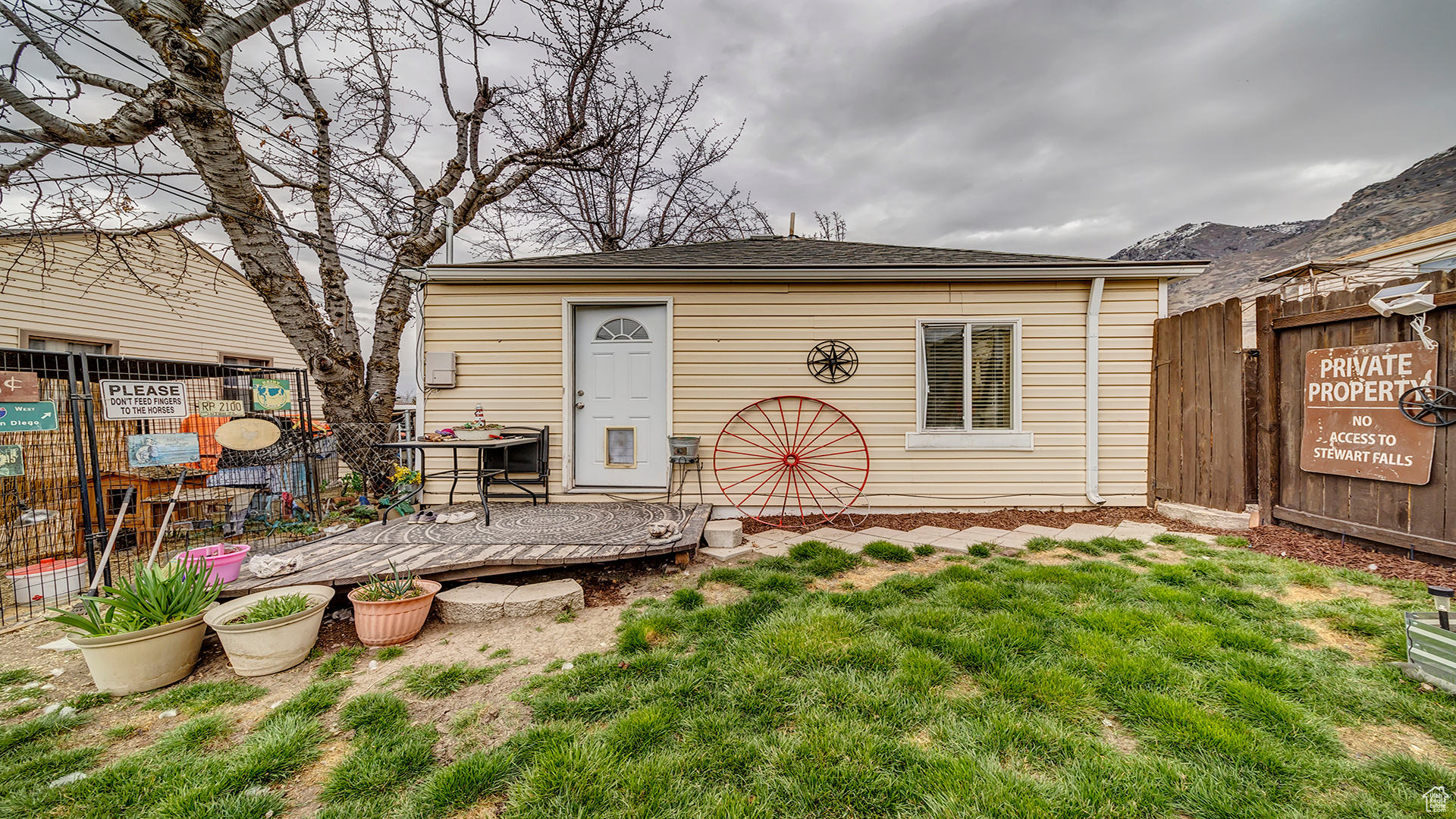 Back of property with a lawn and a deck