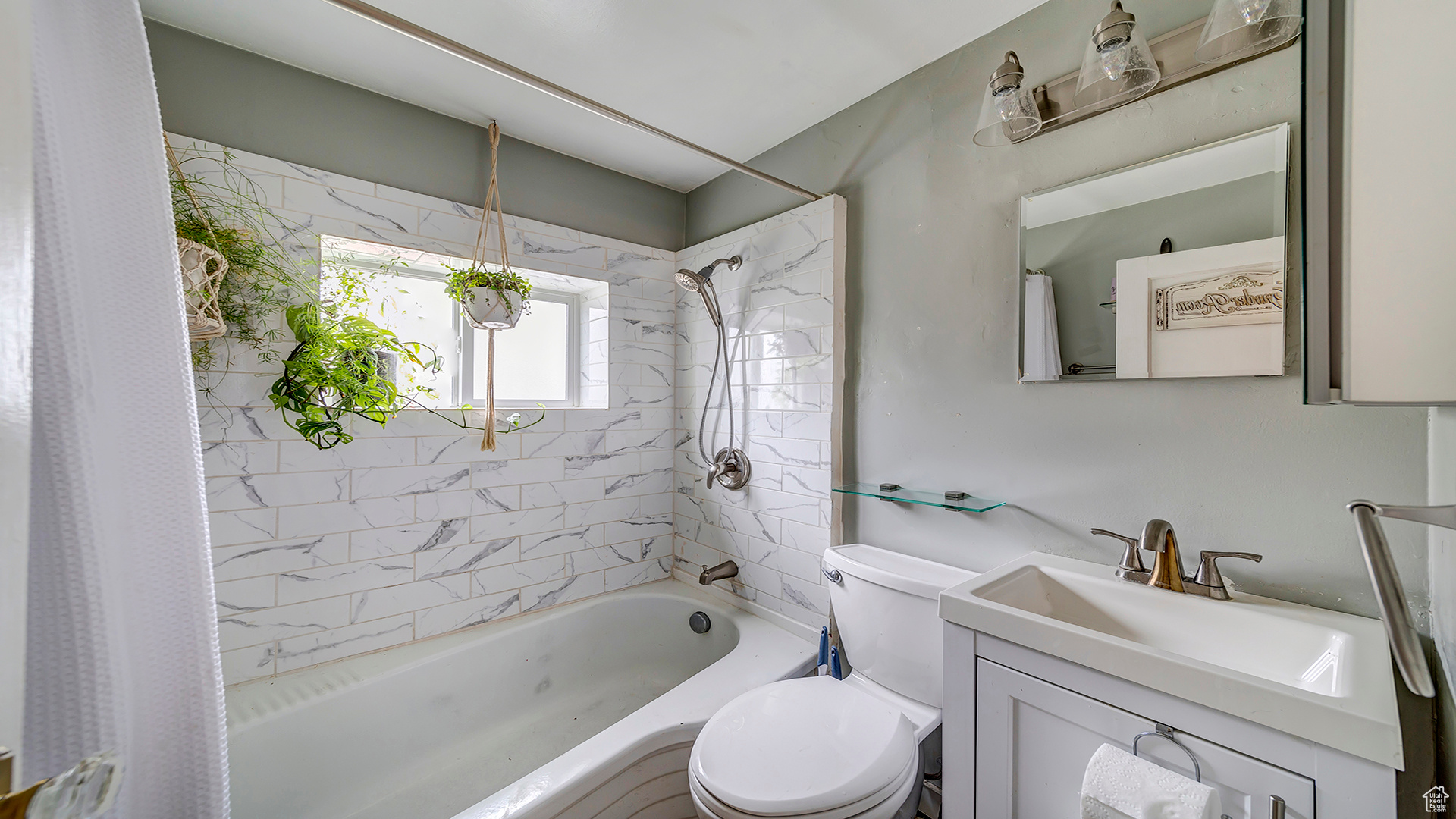 Full bathroom featuring vanity, shower / tub combo, and toilet