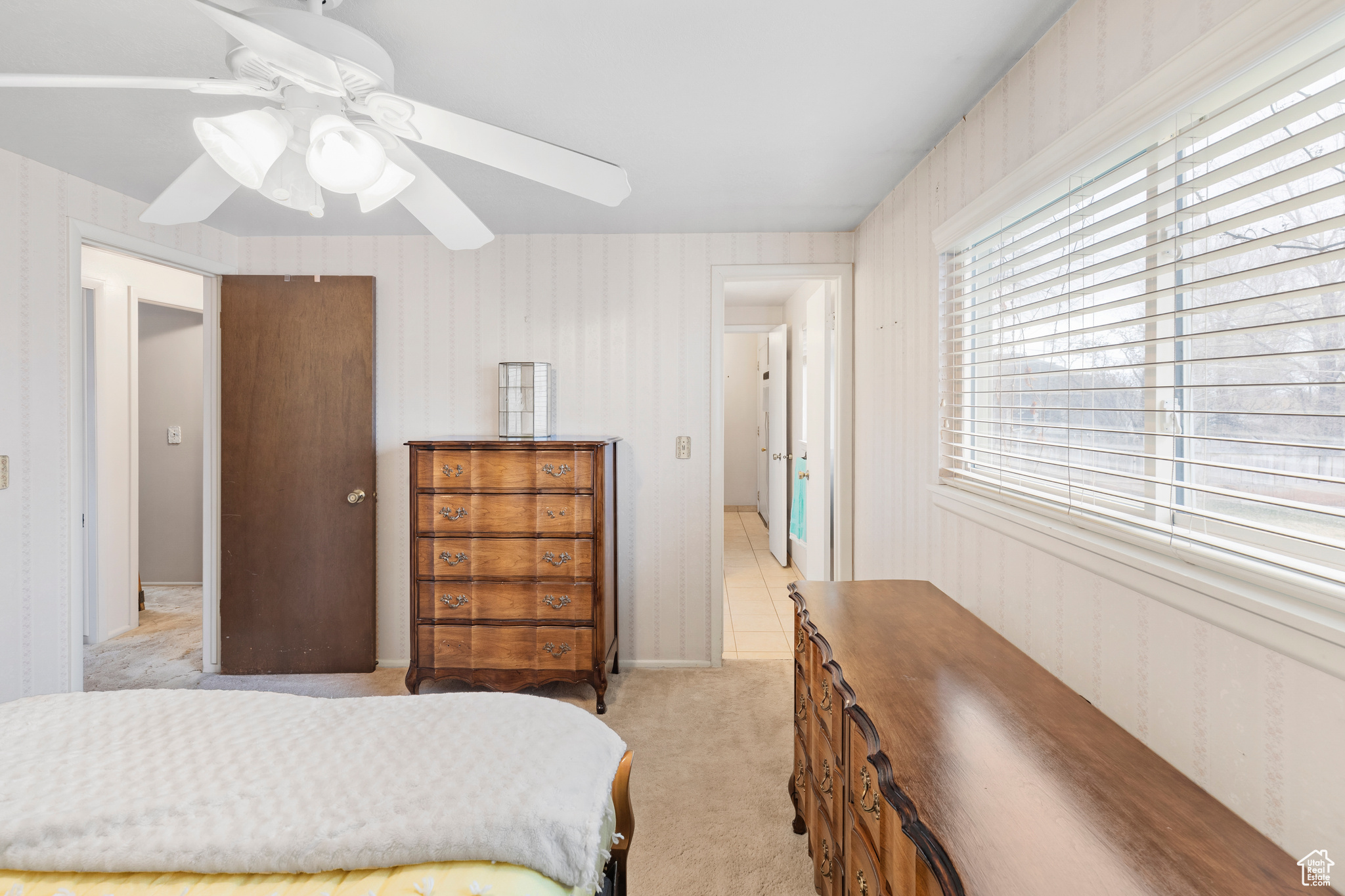 Carpeted bedroom with ceiling fan