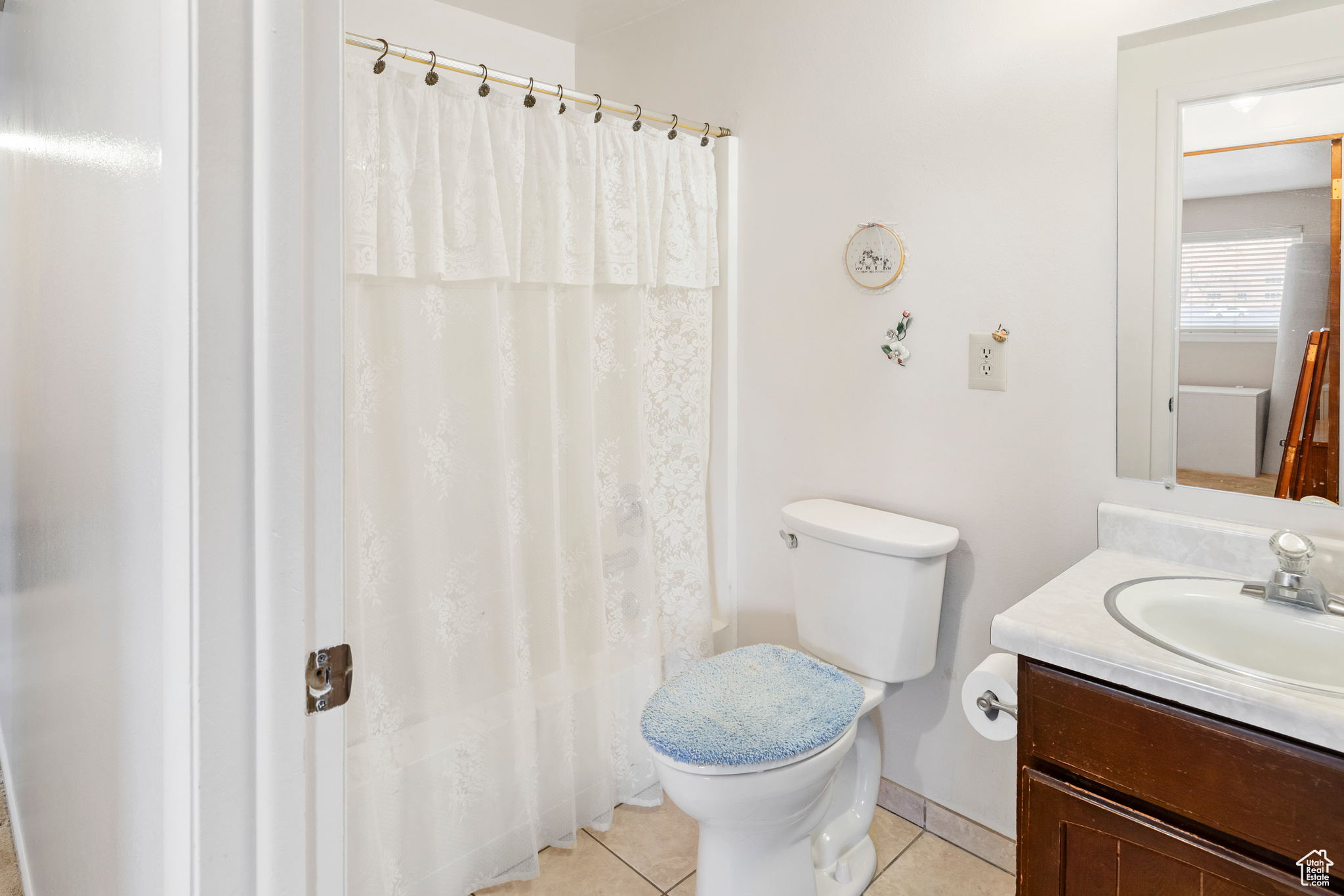 Bathroom with vanity, toilet, and tile flooring