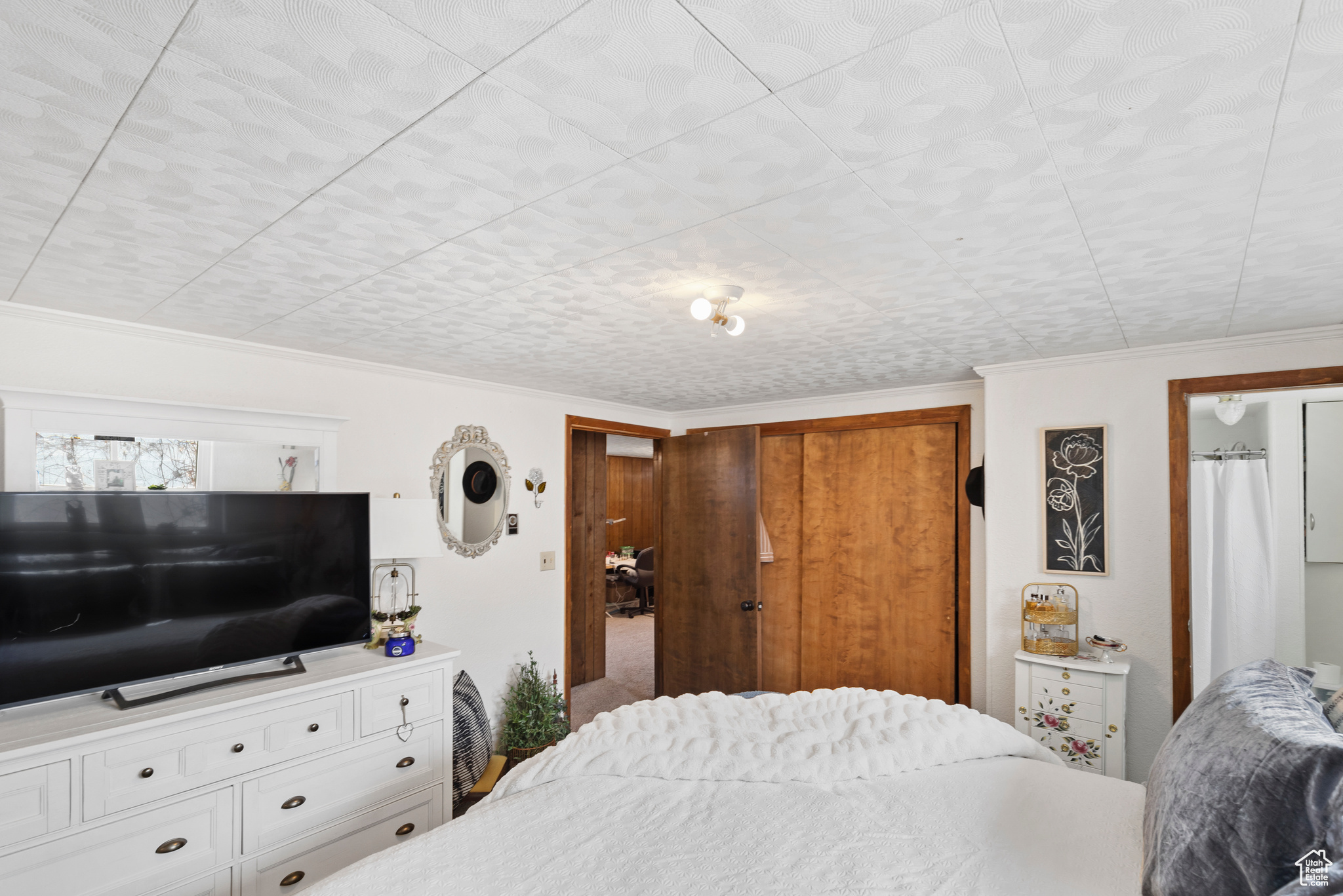 Bedroom featuring ornamental molding and a closet