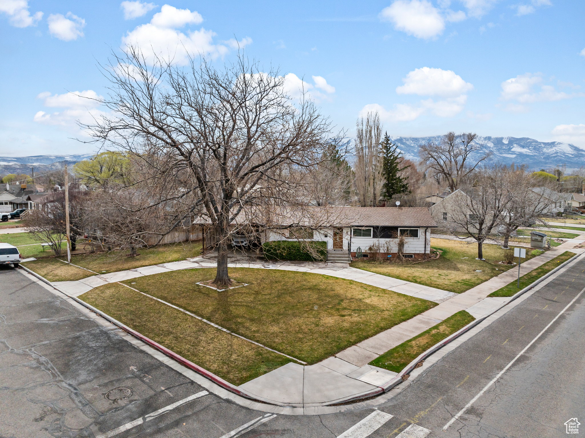 View of front of home with a front yard and a mountain view