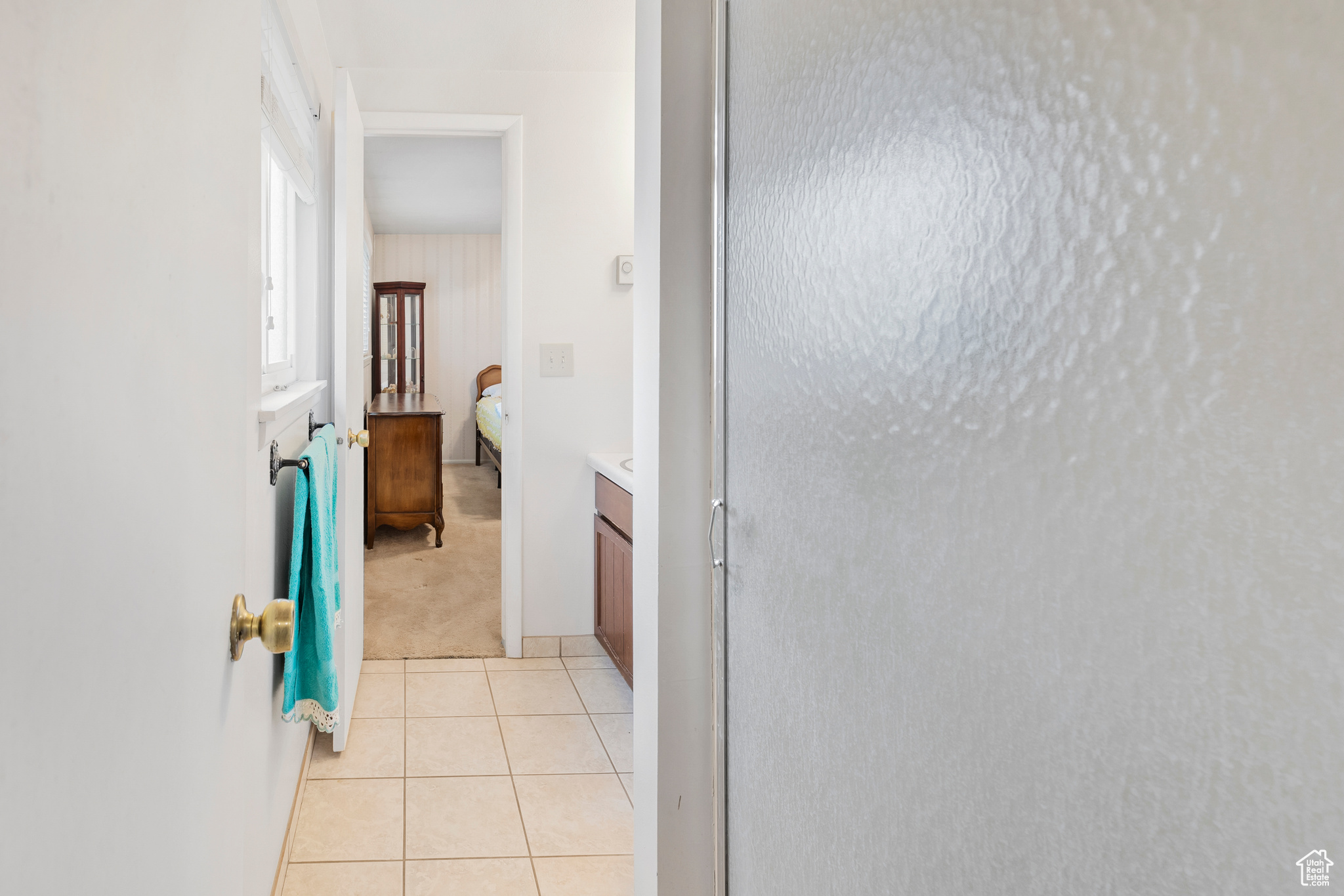 Hallway with light tile flooring