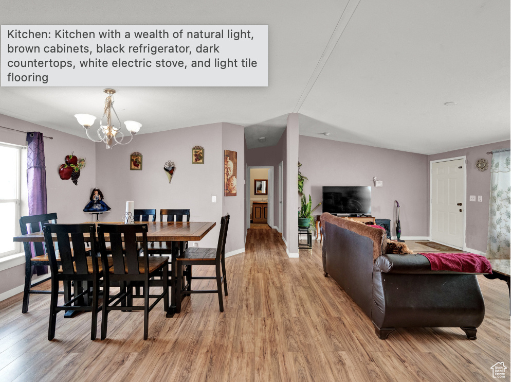 Dining space with an inviting chandelier and light wood-type flooring