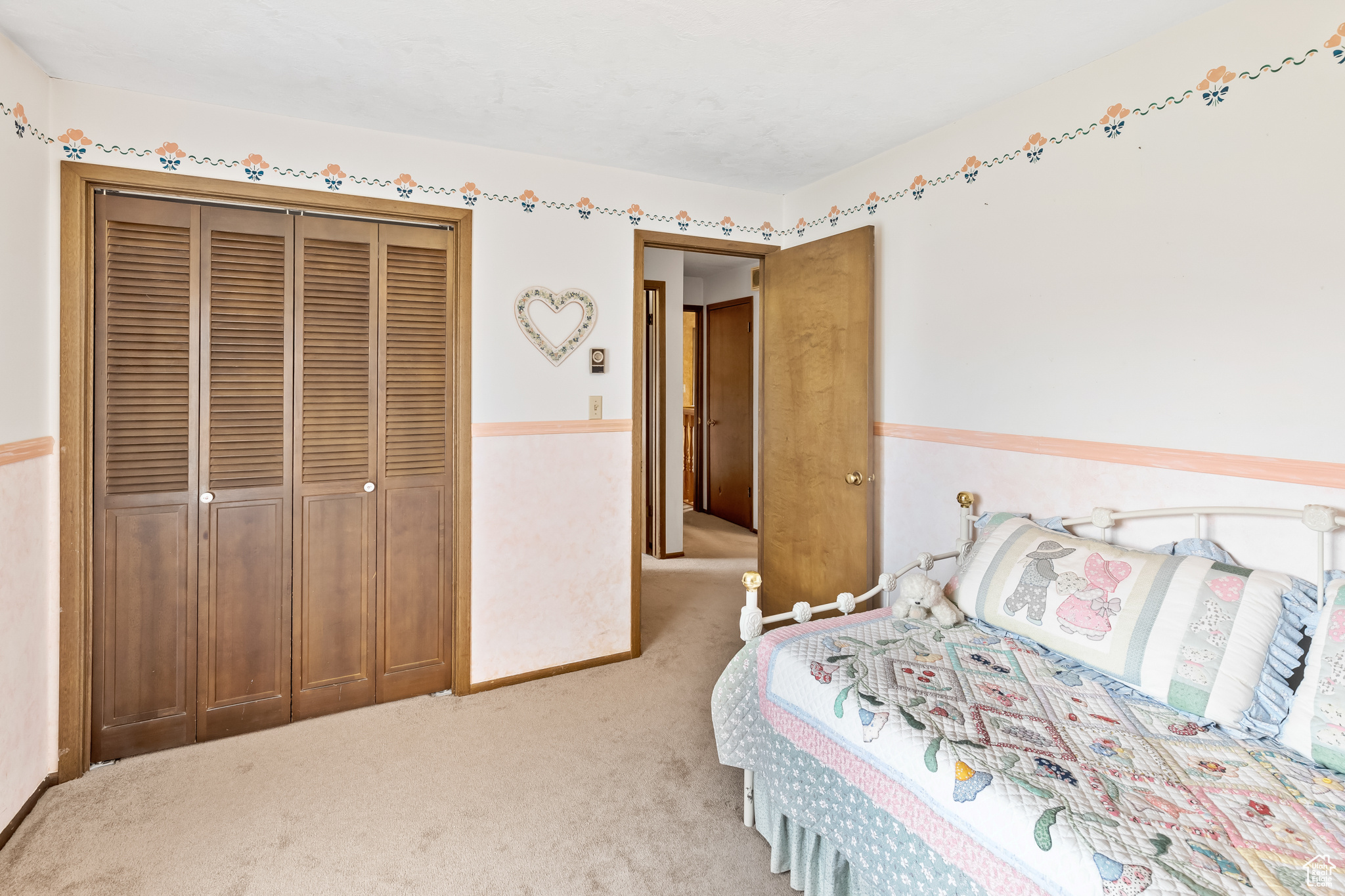 Carpeted bedroom with a closet