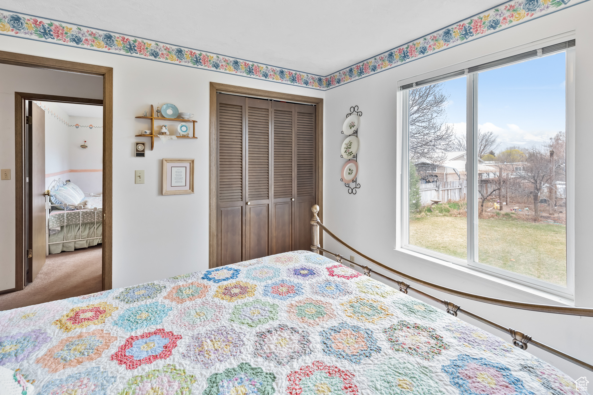 Carpeted bedroom with a closet