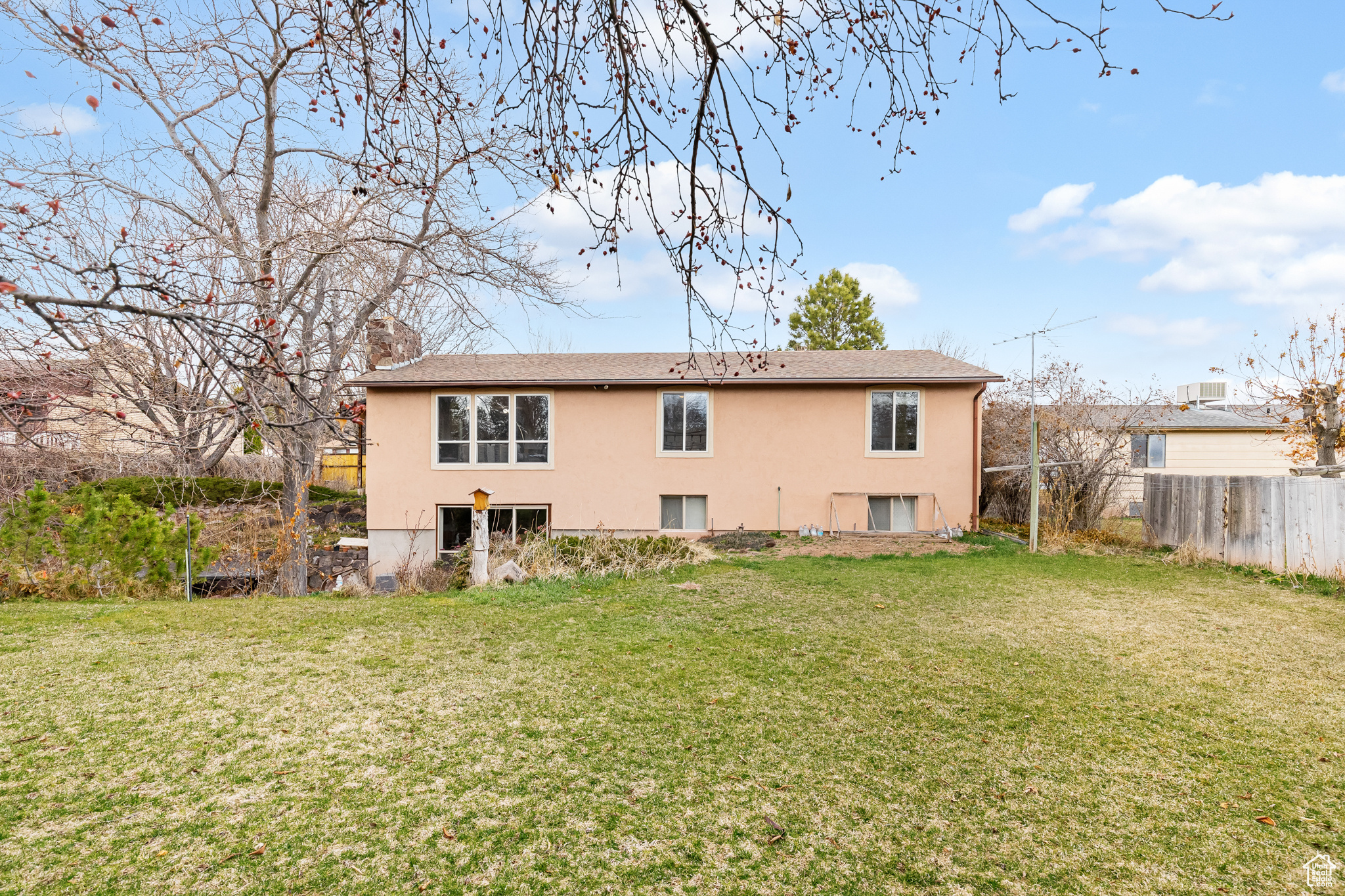 Rear view of property featuring a yard