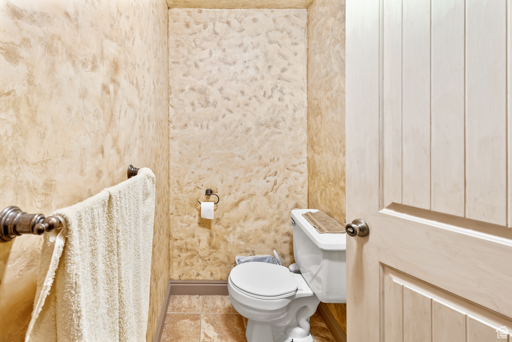 Bathroom featuring tile flooring and toilet