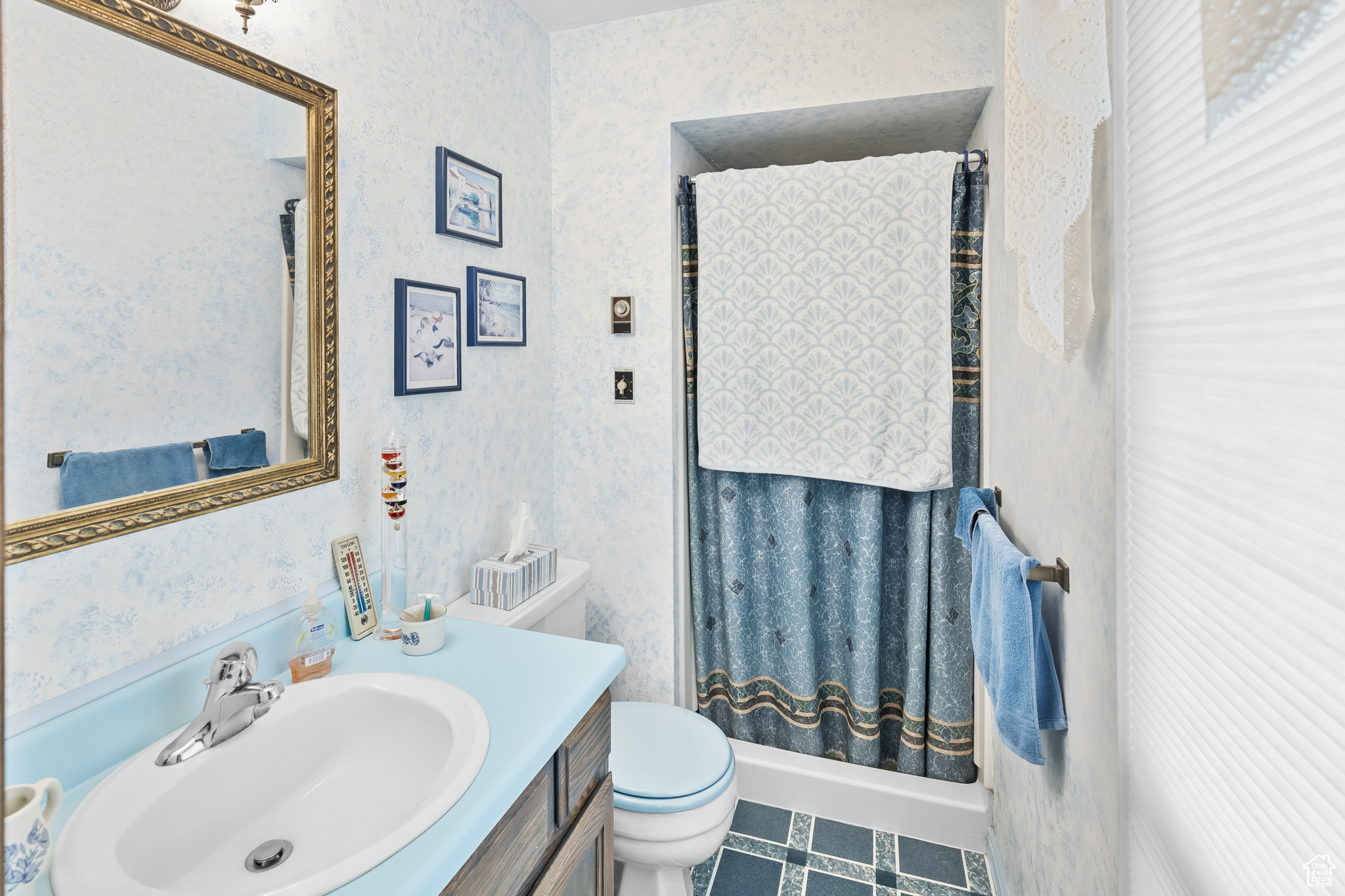 Bathroom with vanity, toilet, and tile floors