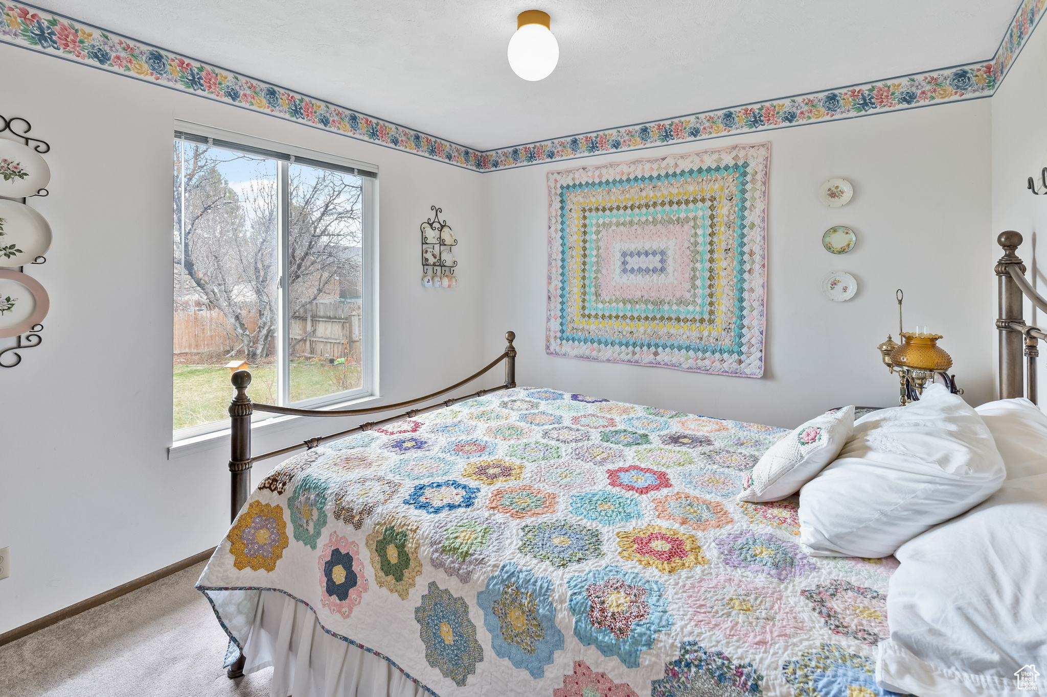 Carpeted bedroom with multiple windows