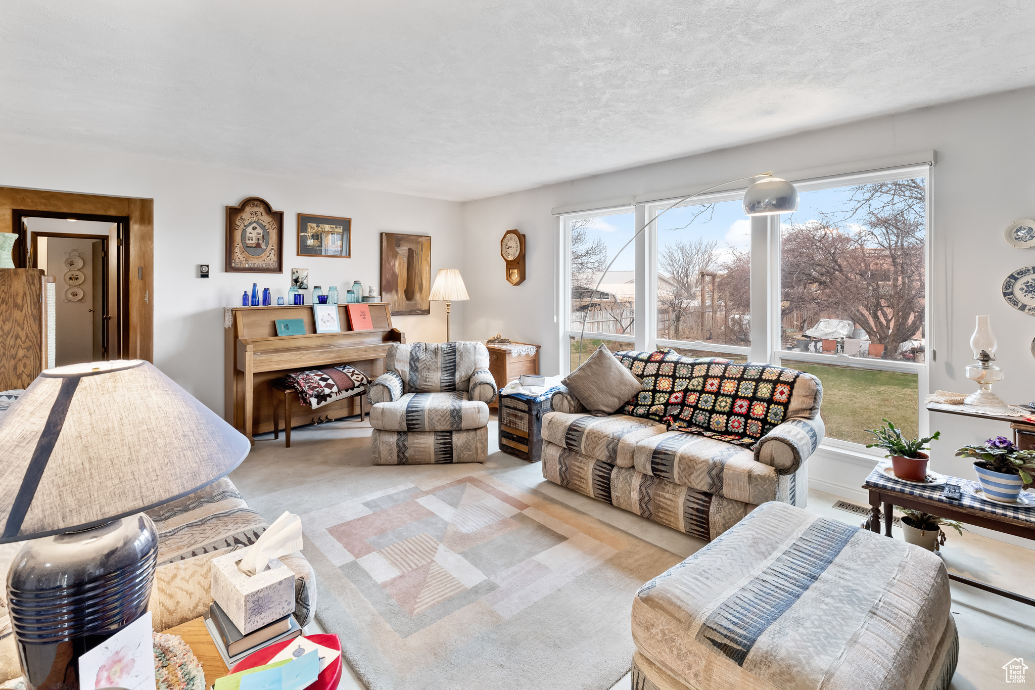 Carpeted living room with a textured ceiling