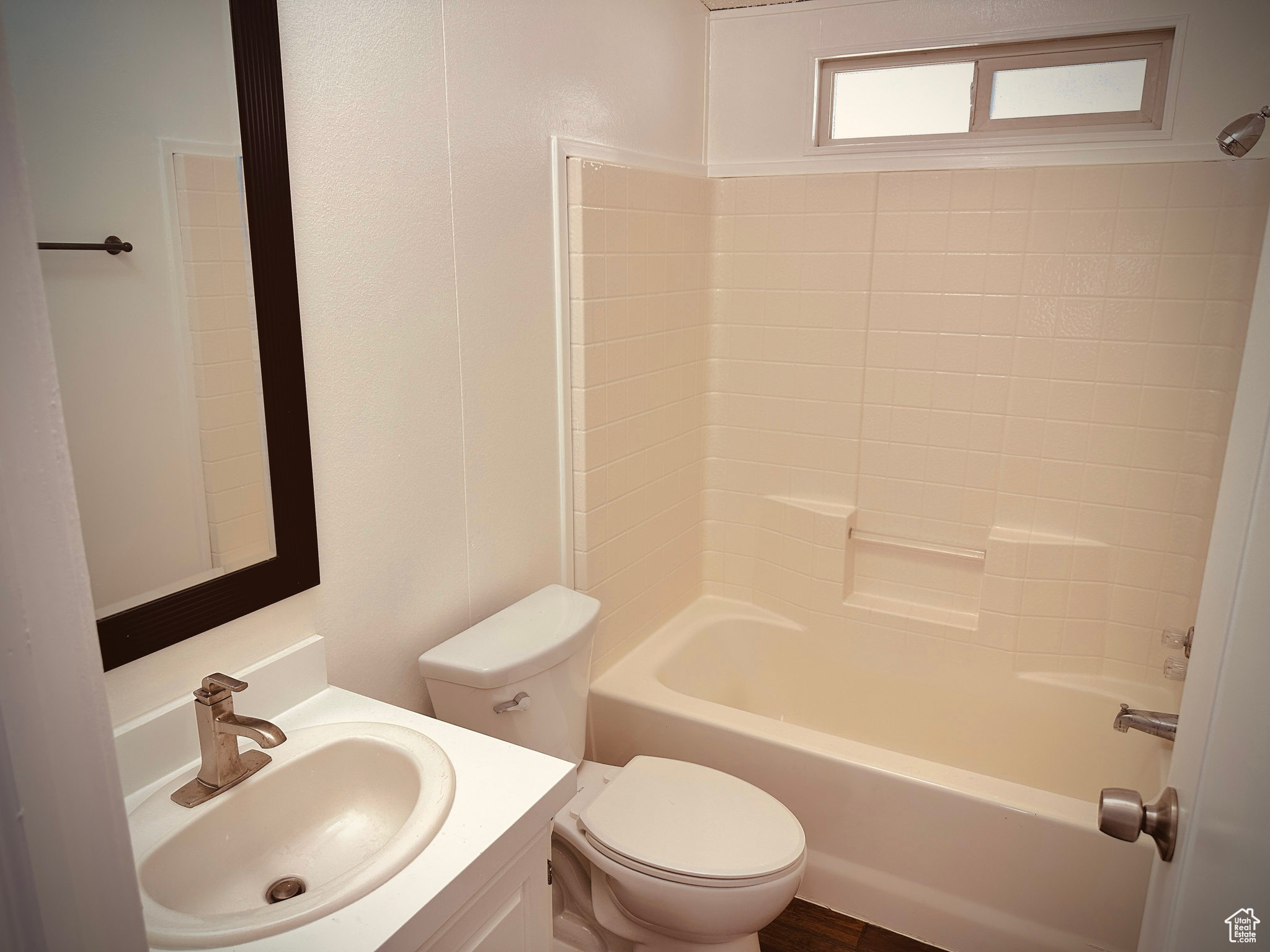 Full bathroom featuring vanity, toilet, and tub / shower combination