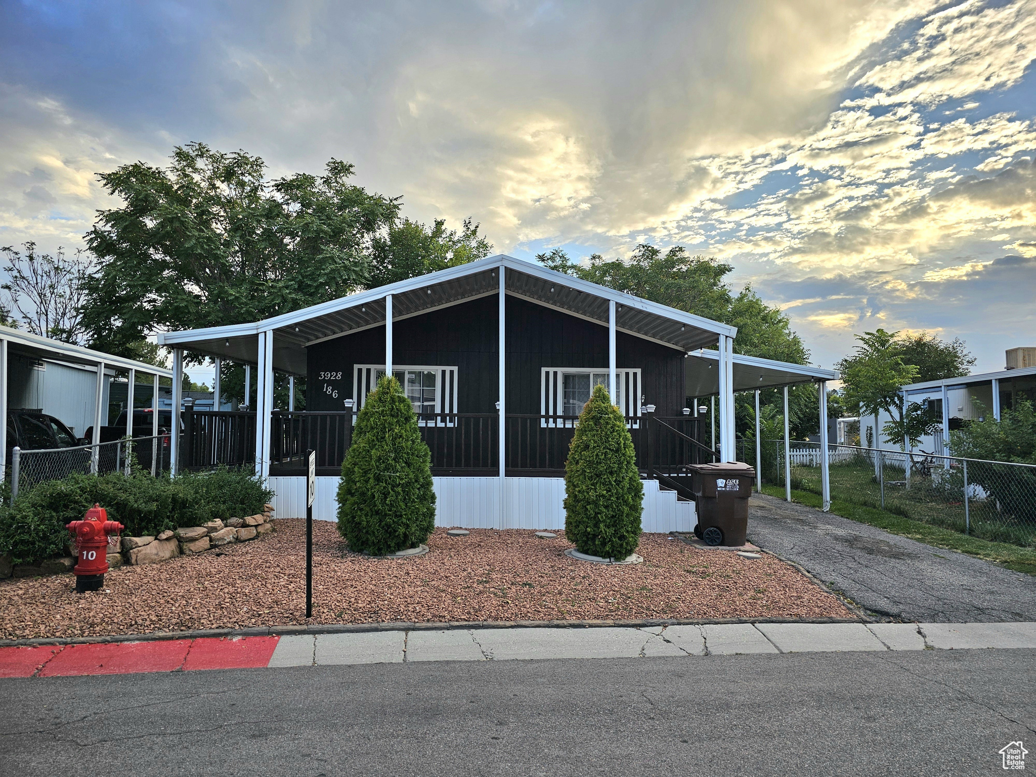 Manufactured / mobile home with a carport and a porch