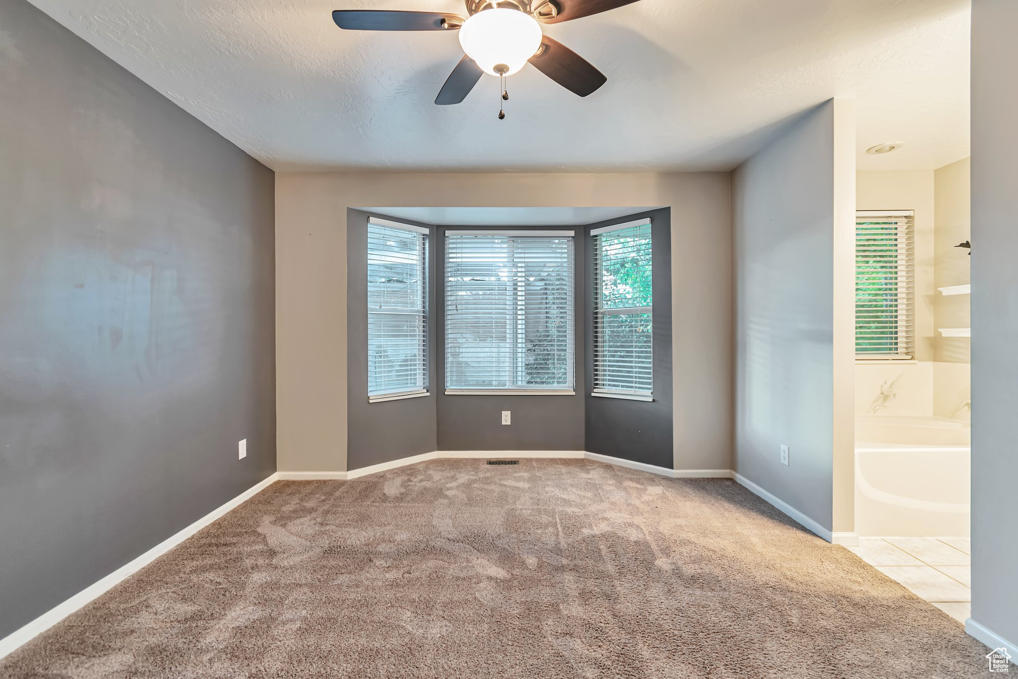 Master bedroom with ensuite bathroom, carpeted with large lookout windows, walk-in closet.