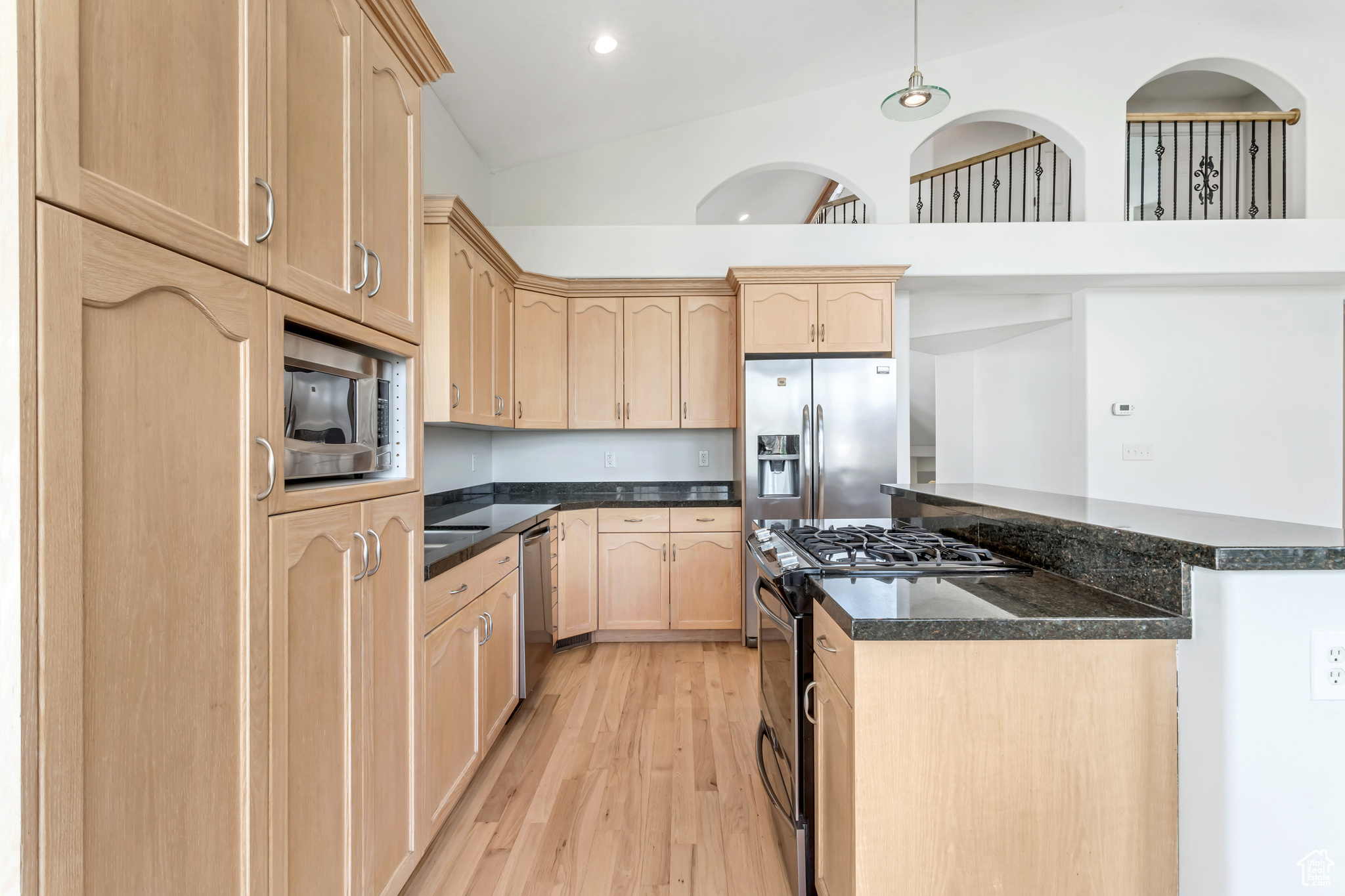 Classic wood cabinets with a fresh modern twist, stainless steel appliances, and island perfect for entertaining