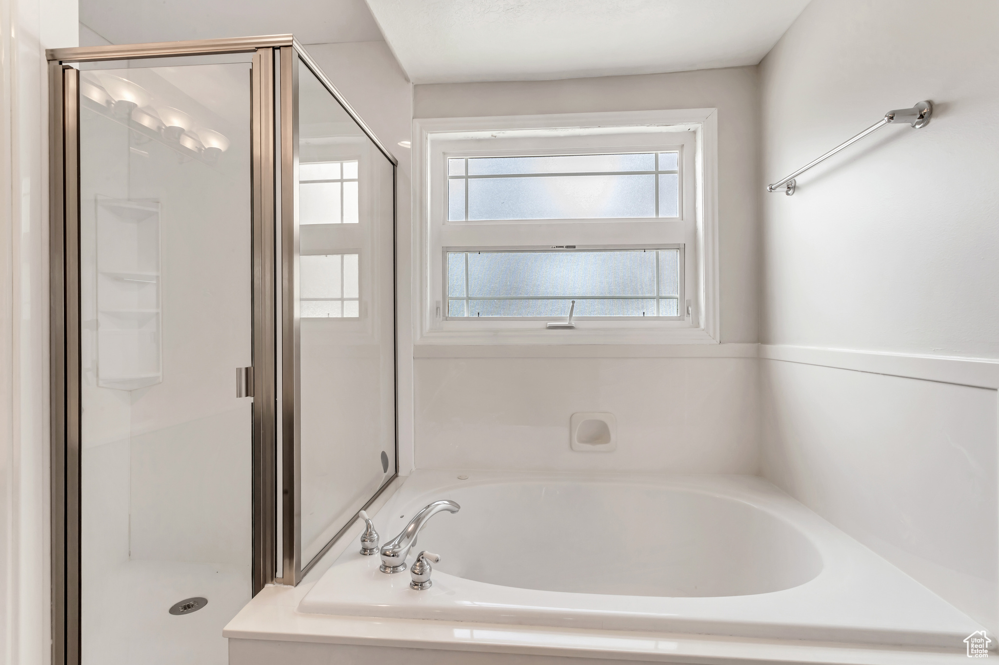 Large soaking tub and separate shower in bathroom for primary suite in main level