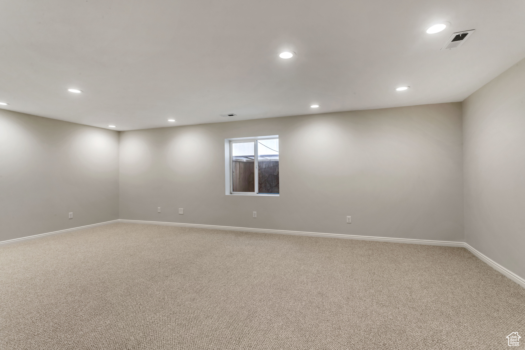 Huge family room in basement with kitchenette with all new carpet . Perfect space for guests, entertaining, or privacy.