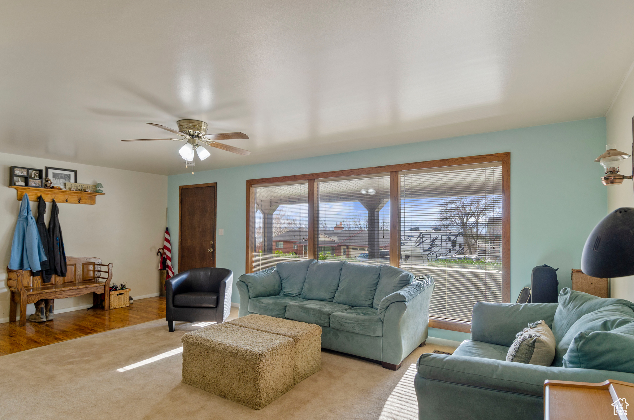 Living room featuring light hardwood and ceiling fan