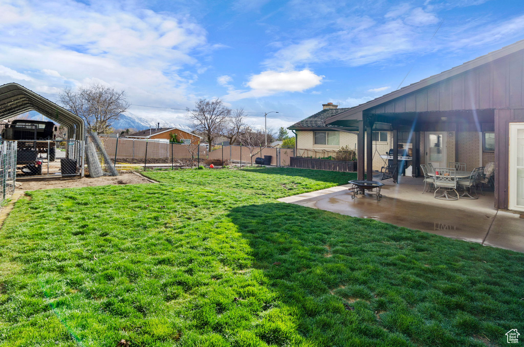 View of yard featuring a patio and a carport.