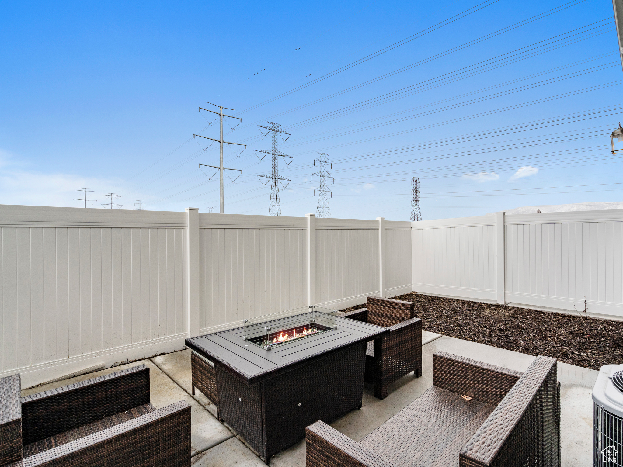 View of terrace featuring an outdoor living space with a fire pit, fully fenced