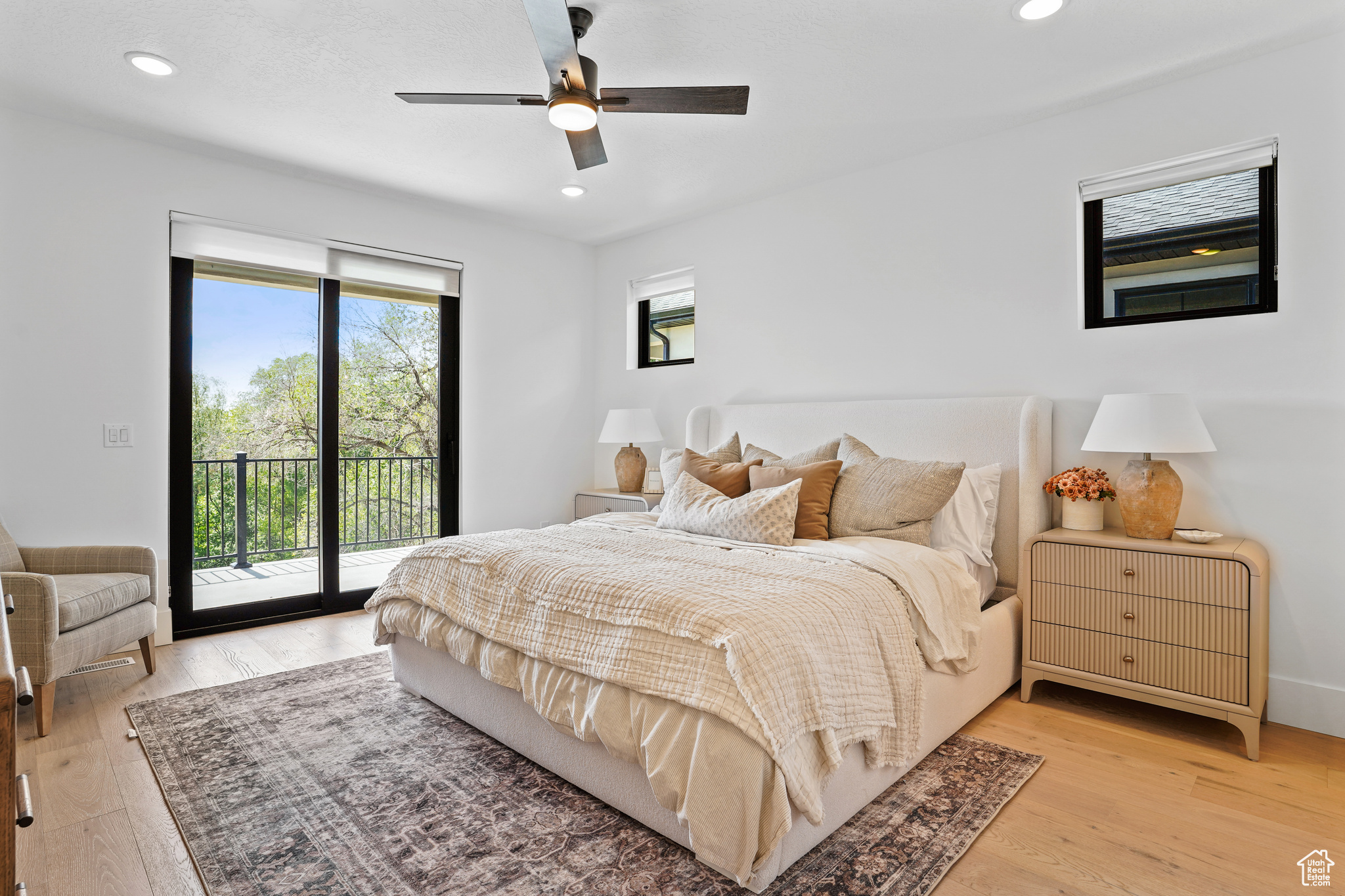 Bedroom featuring ceiling fan, light hardwood / wood-style floors, and access to outside