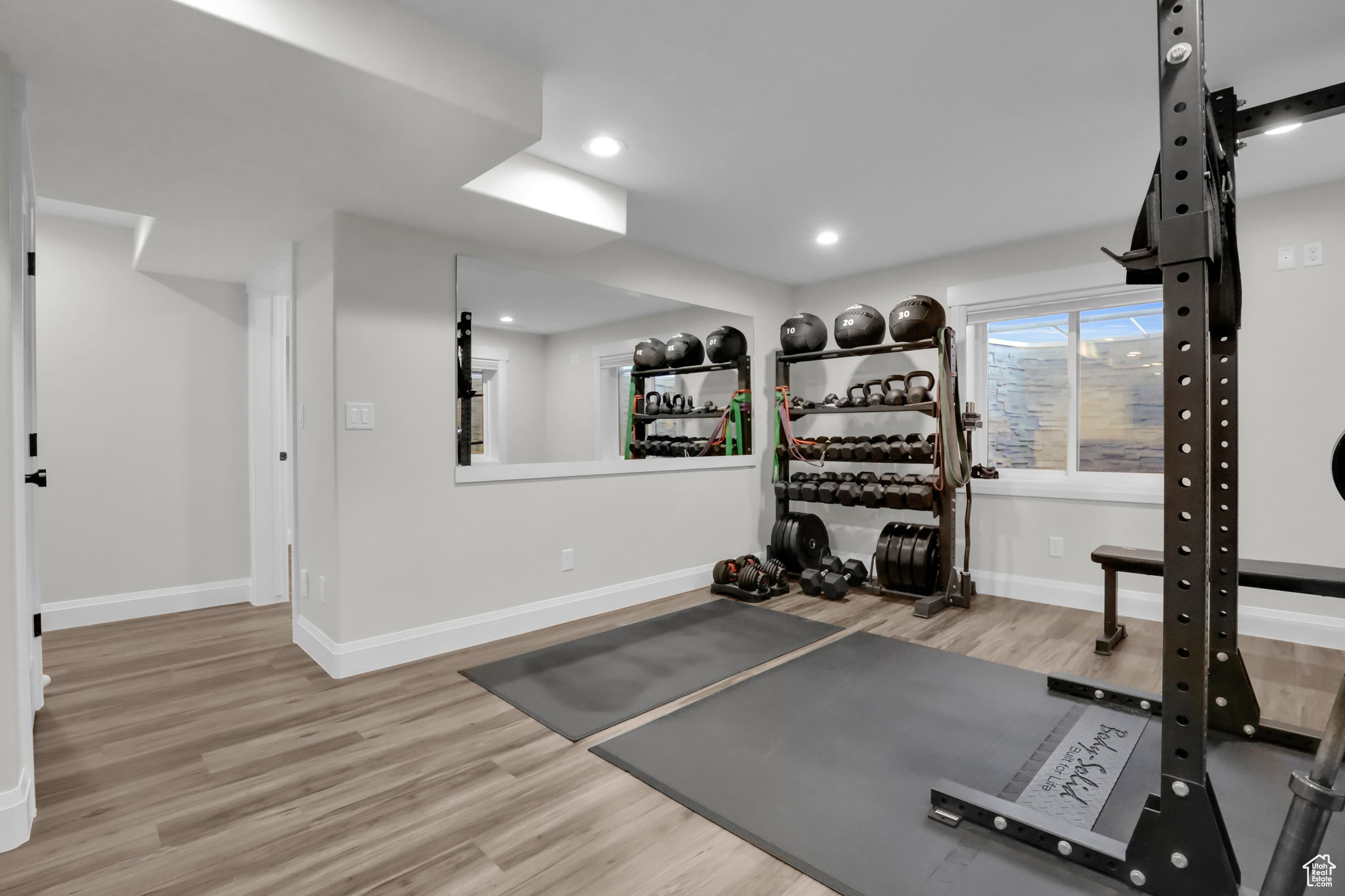 Workout room with light hardwood / wood-style floors