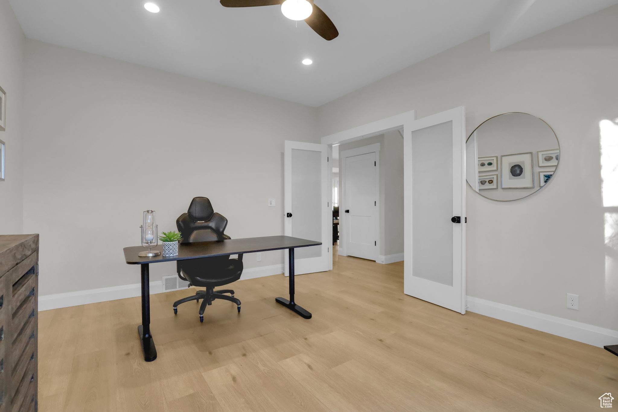 Office area featuring ceiling fan and light hardwood / wood-style floors