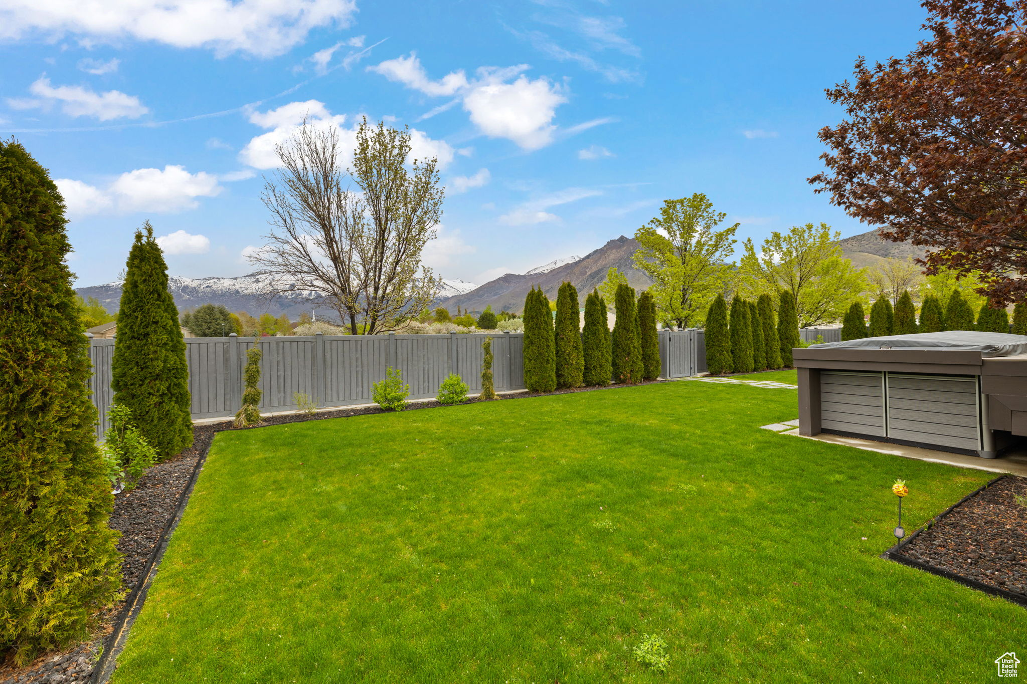 View of yard with a mountain view and a hot tub