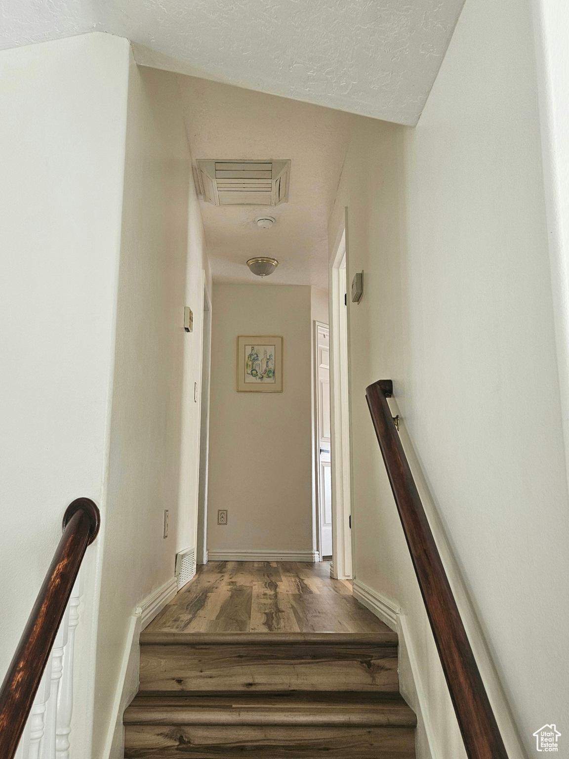 Stairs up to master, 2 bedrooms, hallway bathroom and linen closet