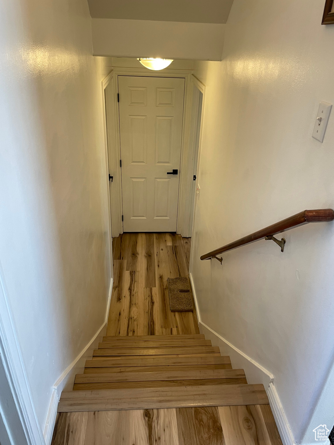 Stairs leading down to bedroom, storage room and linen closet