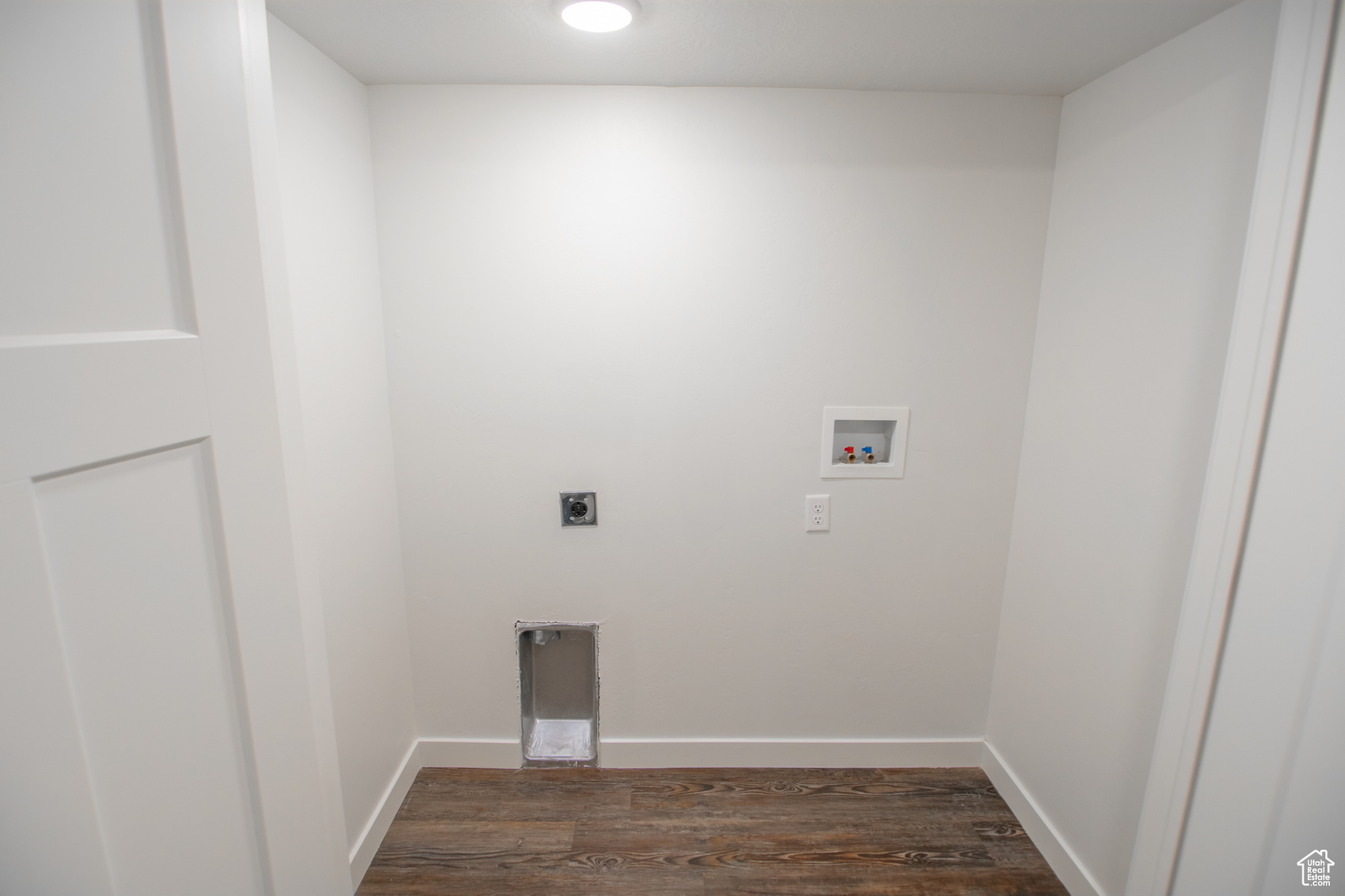Washroom featuring washer hookup, hookup for an electric dryer, and dark wood-type flooring